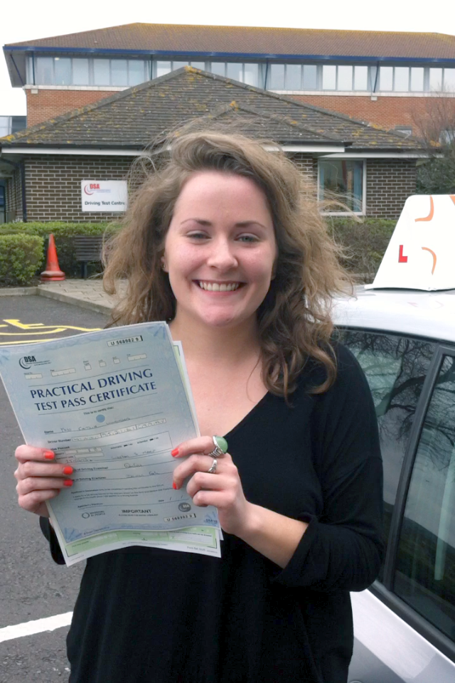 Caitlin with her Practical Driving Test Pass Certificate outside Weston-super-Mare Driving Test Centre.