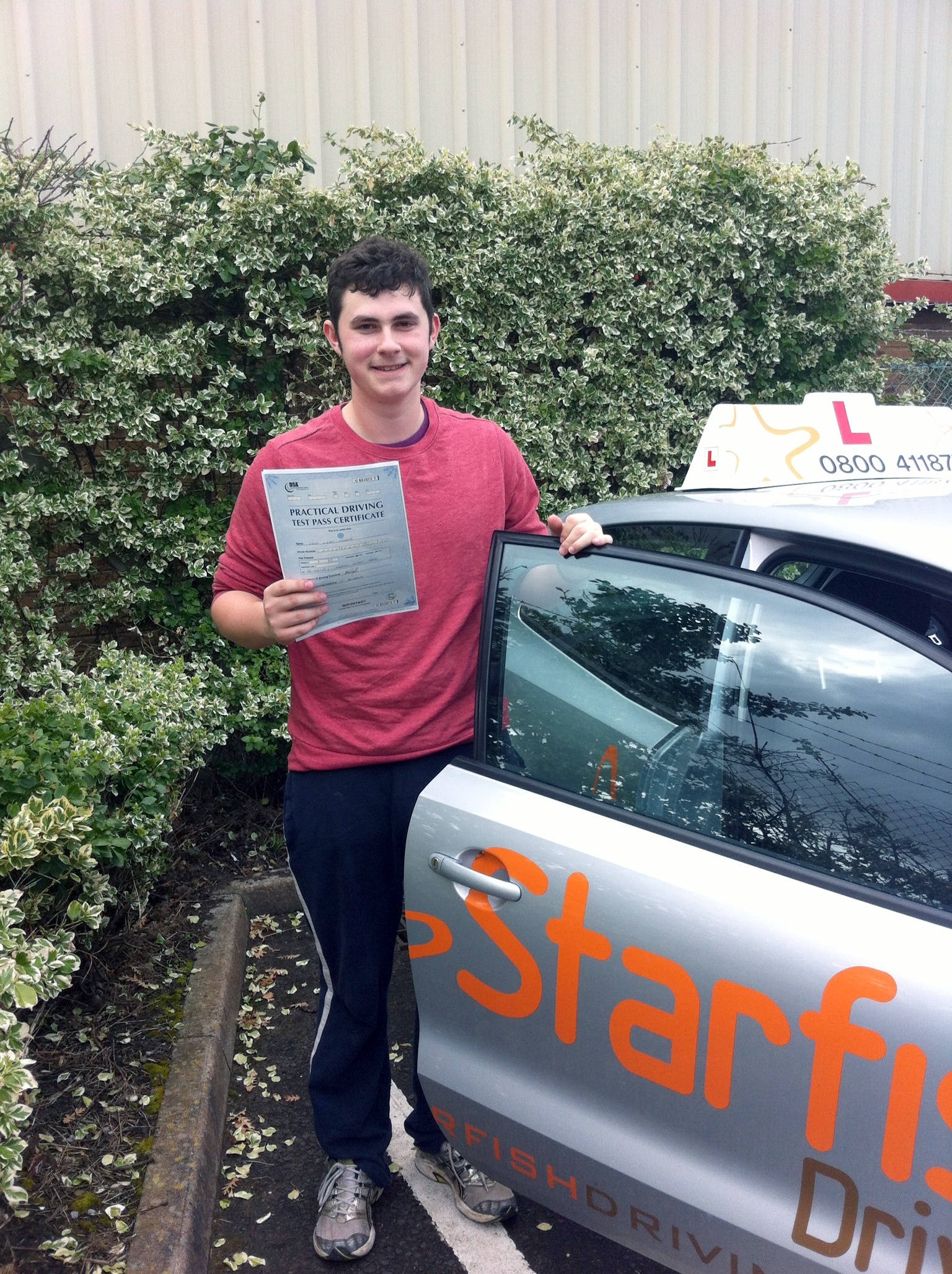 Jack with his Practical Driving Test Pass Certificate outside Weston-Super-Mare Driving Test Centre.