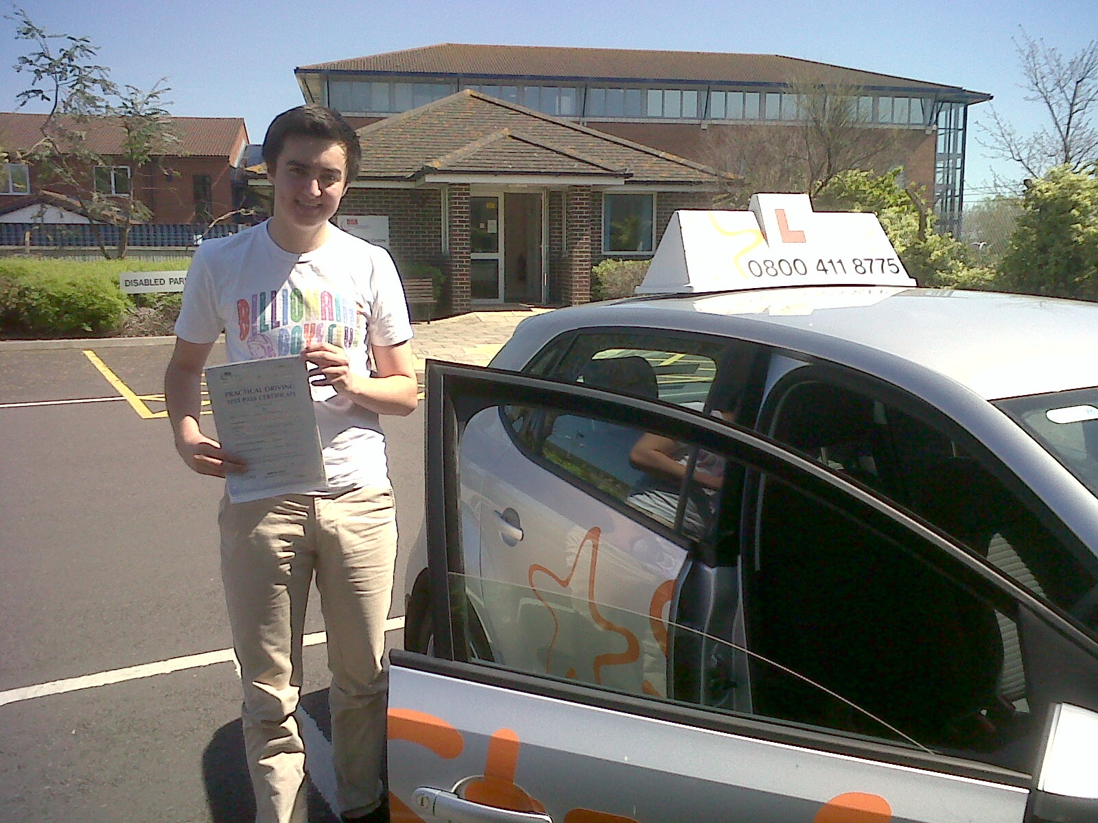 Billy with his Practical Driving Test Pass Certificate outside Weston-Super-Mare Driving Test Centre