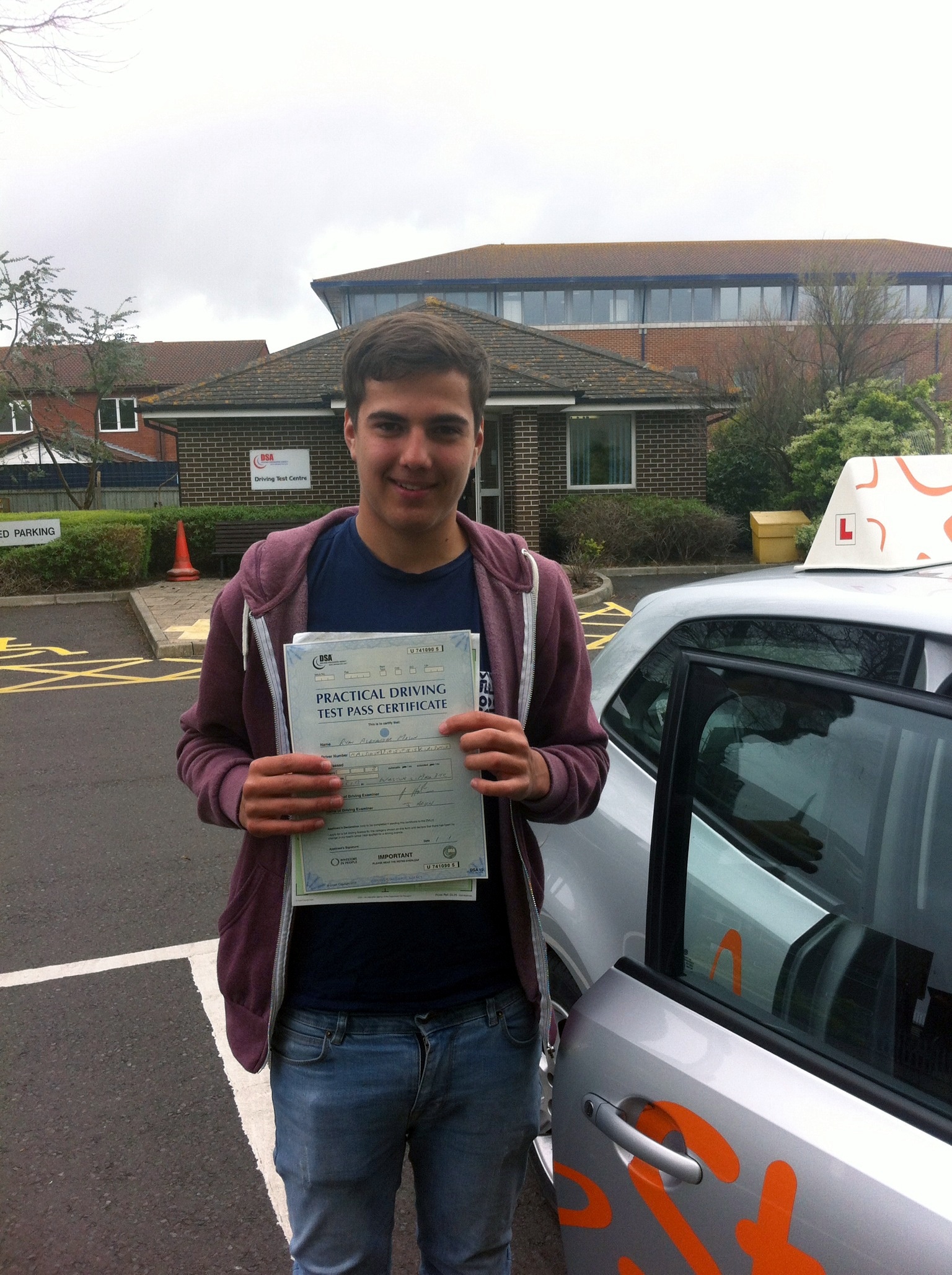 Ryan with his Practical Driving Test Pass Certificate outside Weston-Super-Mare Driving Test Centre