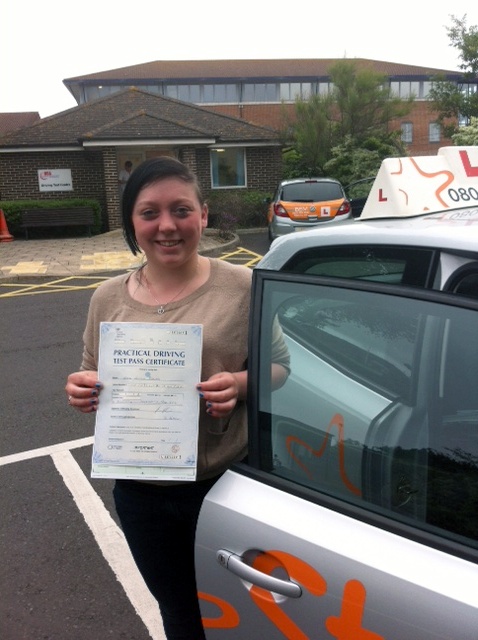 Emma with her Practical Driving Test Pass Certificate outside Weston-super-Mare Driving Test Centre