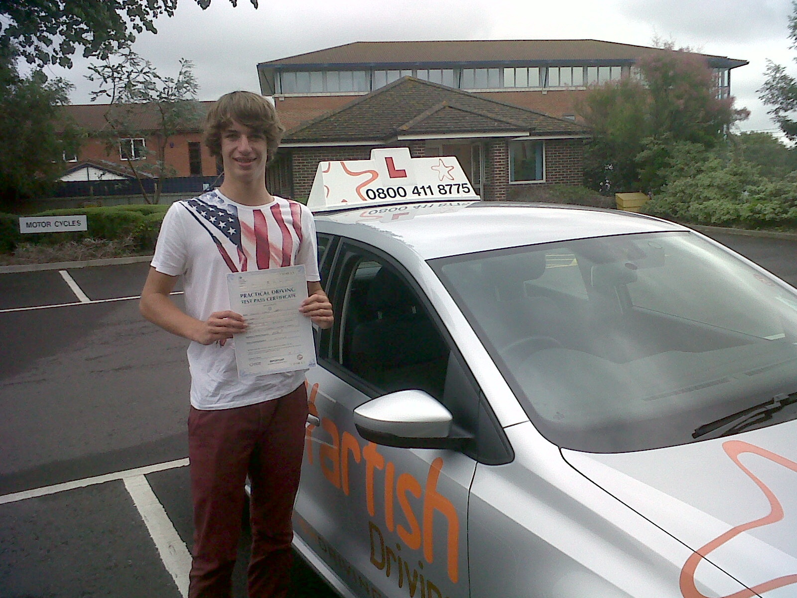 Tom with his Driving Test Pass Certificate outside Weston-super-Mare Driving Test Centre