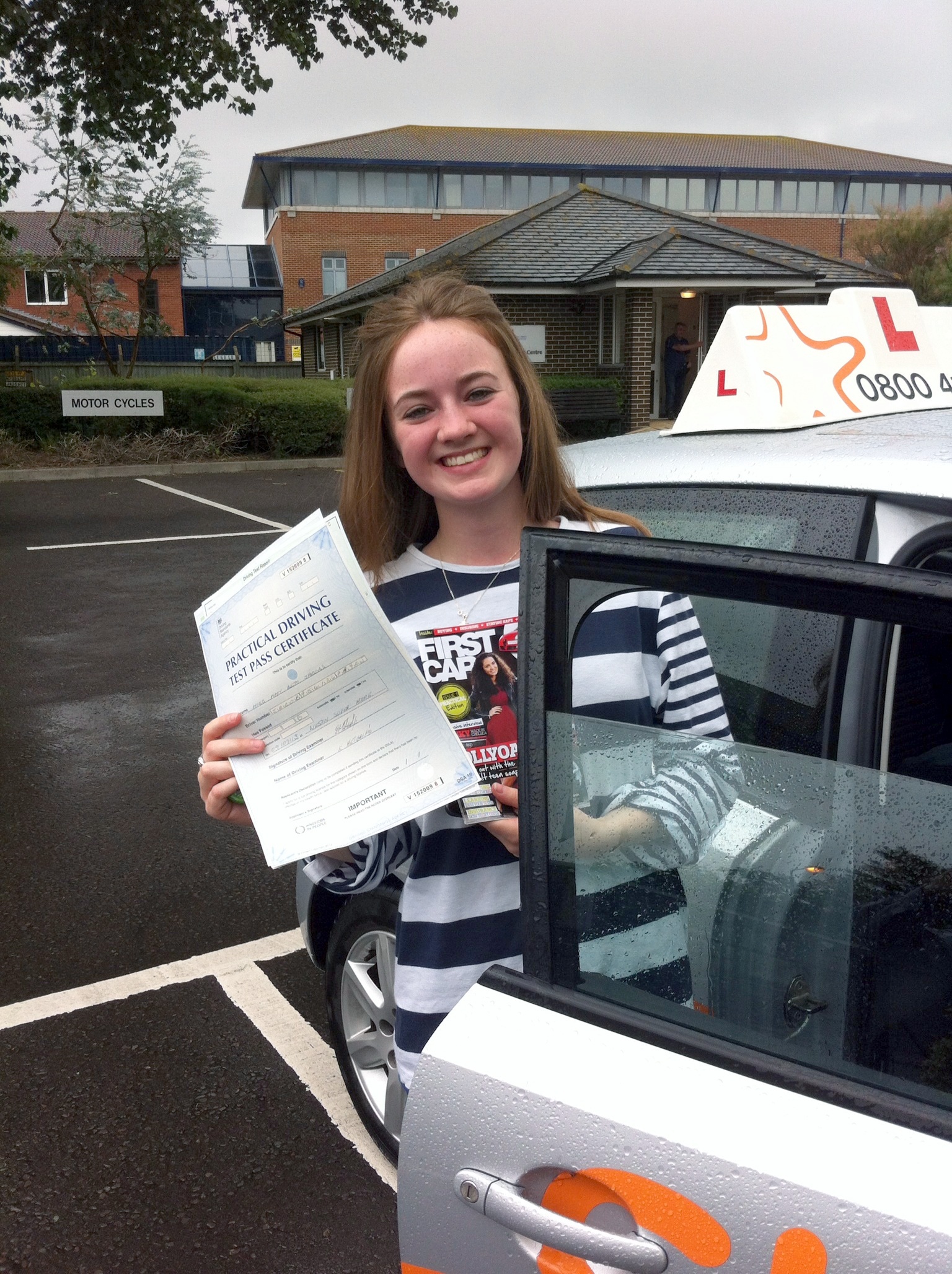 Amy with her Practical Driving Test Pass Certificate outside Weston-super-Mare Driving Test Centre.