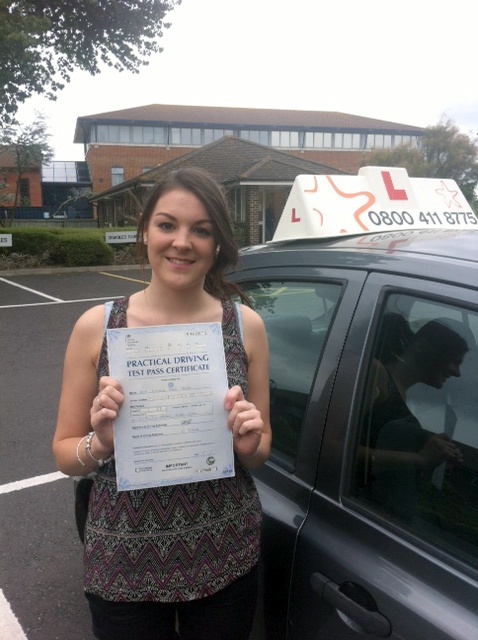 Izzi with her Practical Driving Test Pass Certificate outside Weston-super-Mare Driving Test Centre.