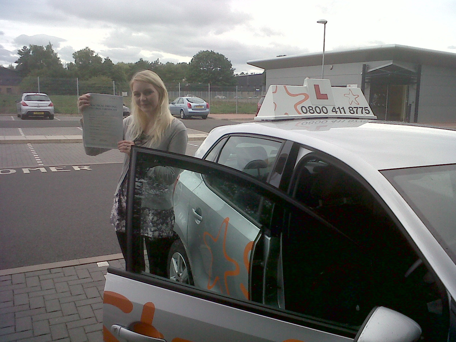 Kirsty with her Practical Driving Test Pass Certificate outside Taunton Driving Test Centre