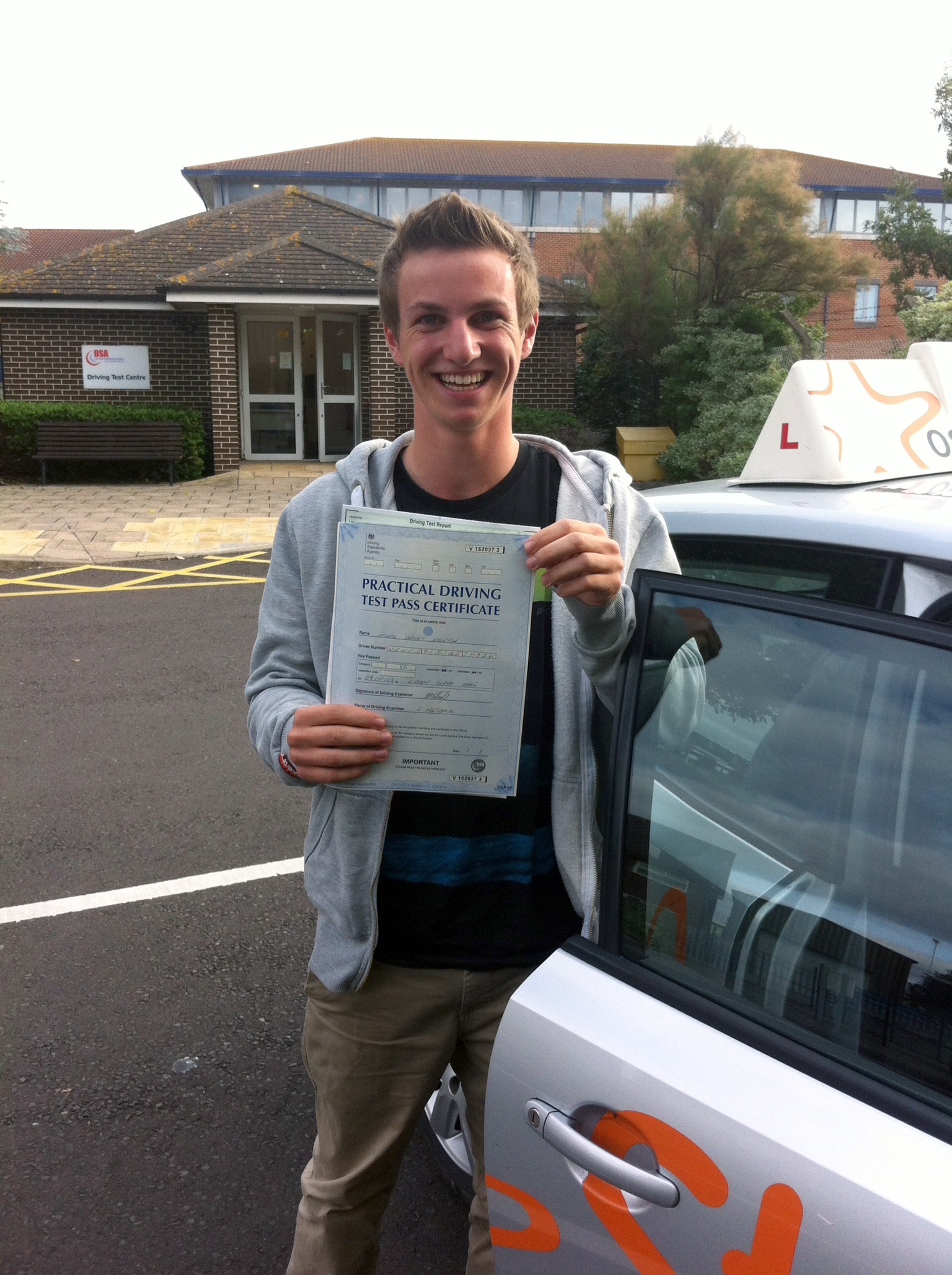 Joe with his Practical Driving Test Pass Certificate outside Weston-Super-Mare Driving Test Centre.