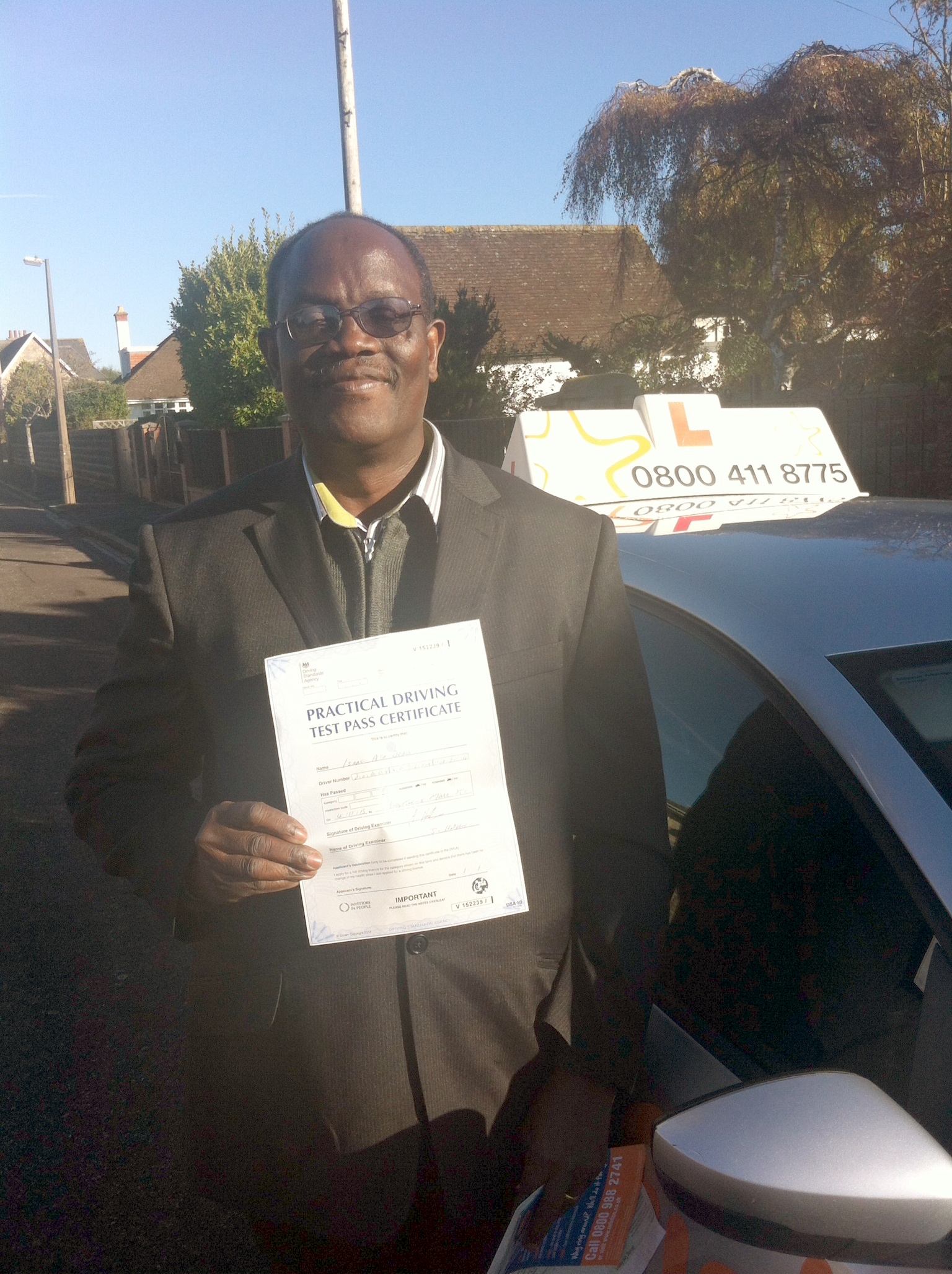 Issac with his Practical Driving Test Pass Certificate somewhere in Weston-Super-Mare