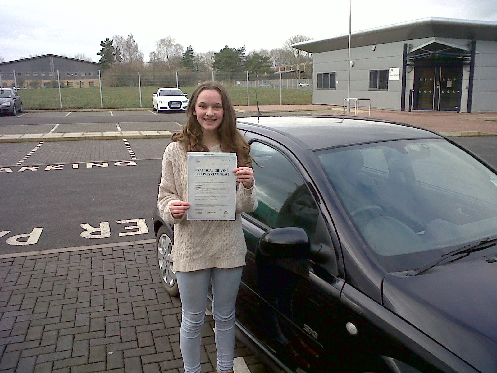 Lottie with her Driving Test Pass Certificate outside Taunton Driving Test Centre.
