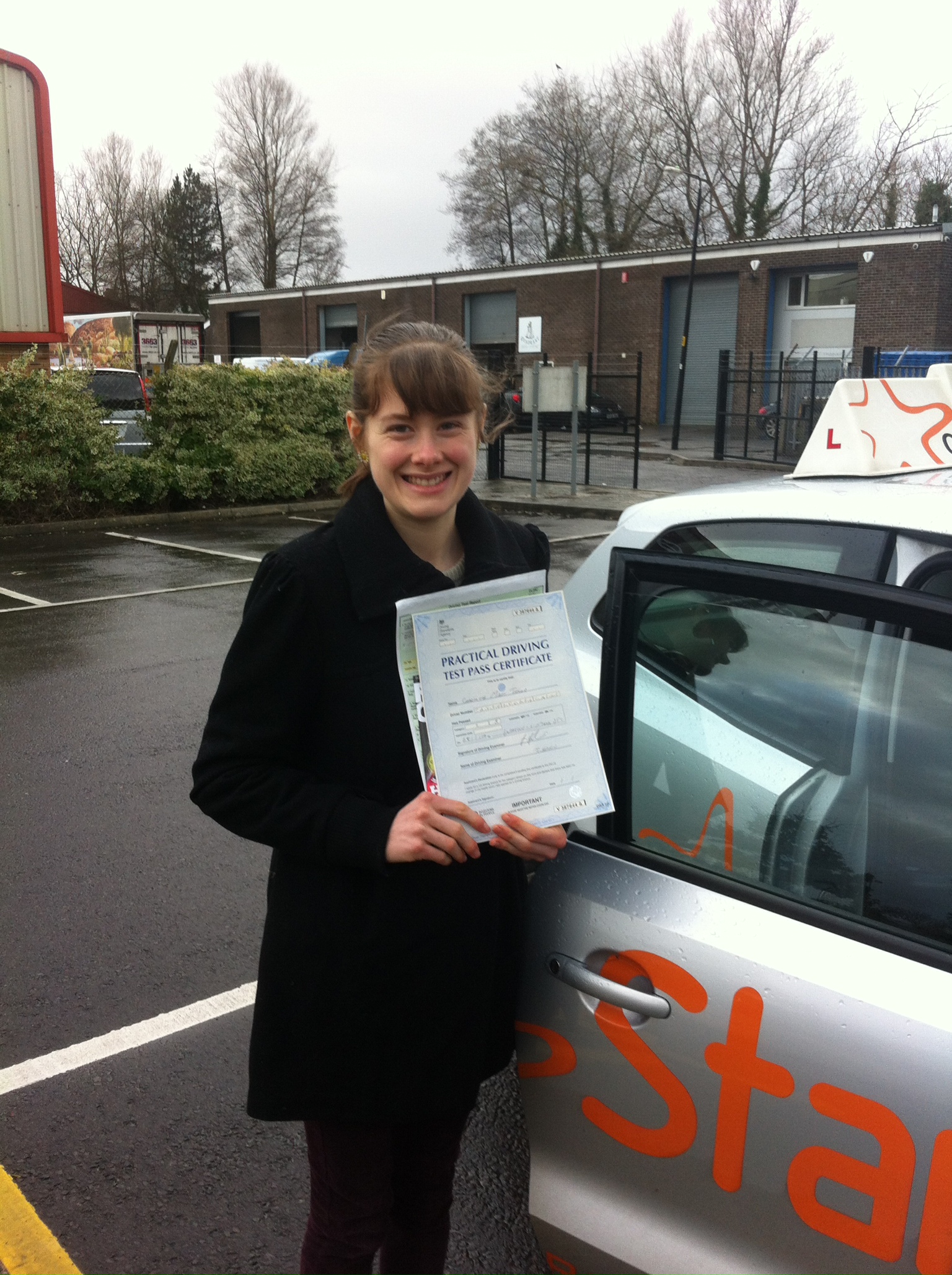 Charlotte with her Driving Test Pass Certificate outside Weston-super-Mare Driving Test Centre
