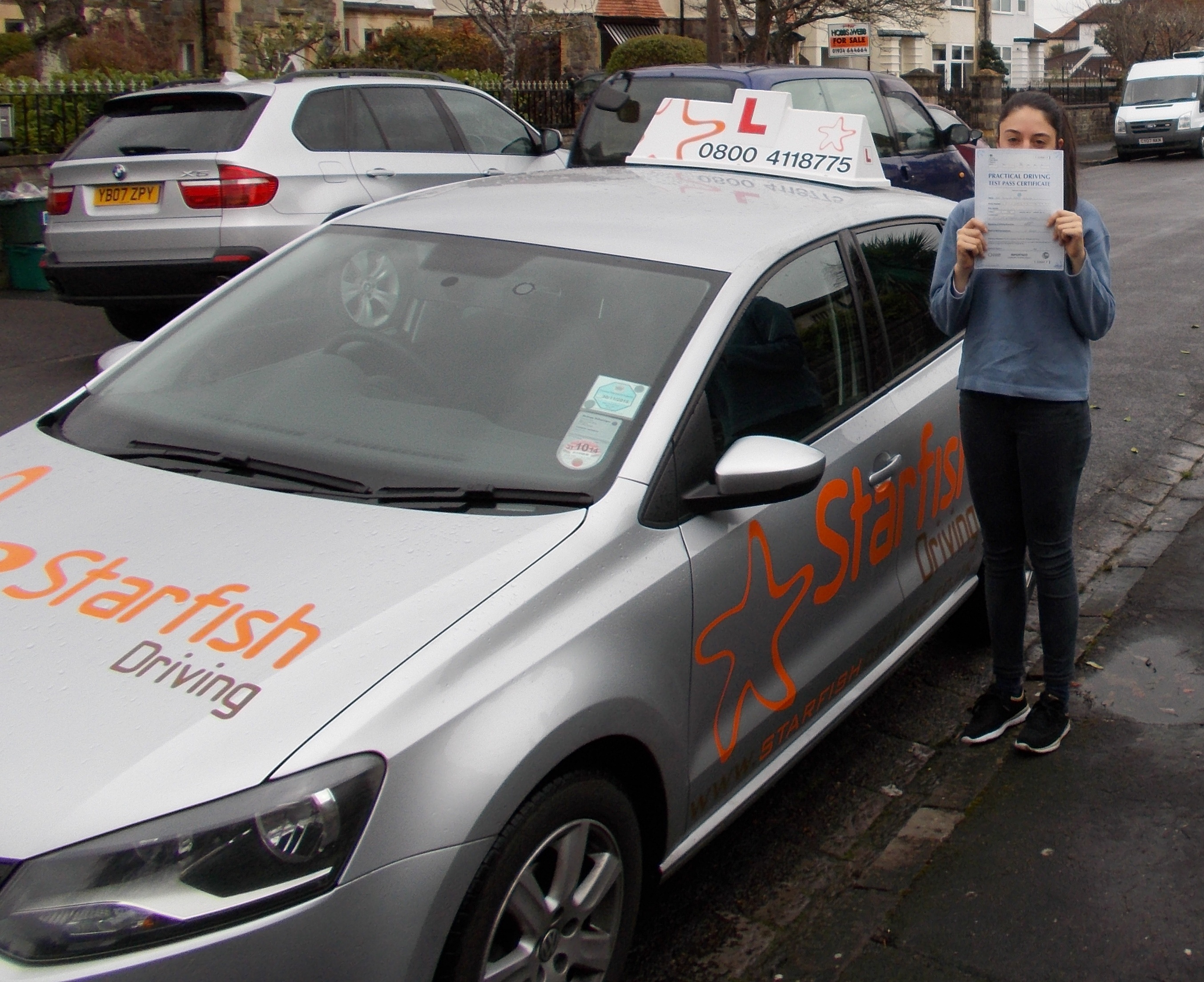 Antonia hiding behind her Driving Test Pass Certificate somewhere in Weston-super-Mare