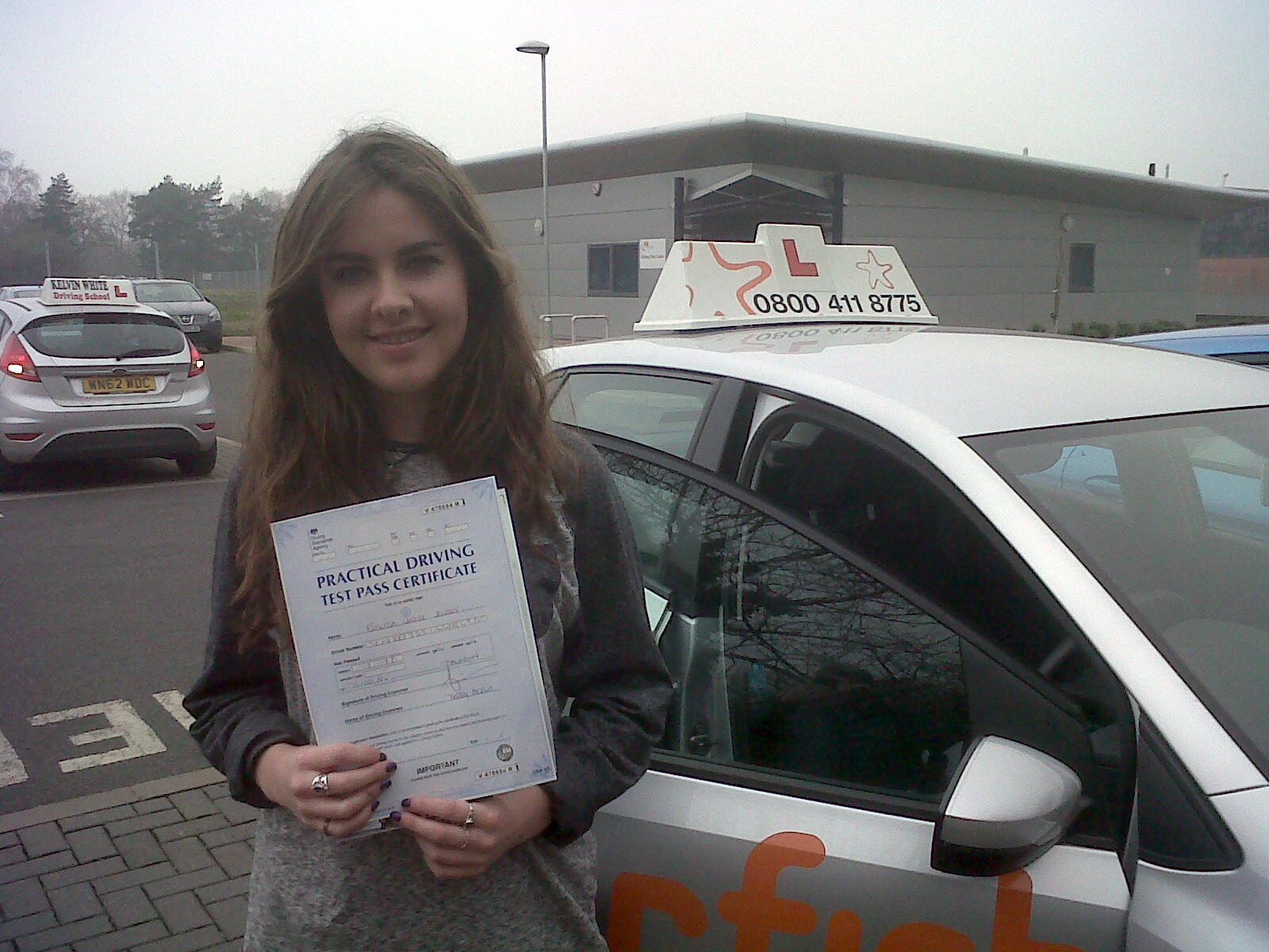 Becky with her Practical Driving Test Pass Certificate outside Taunton Driving Test Centre