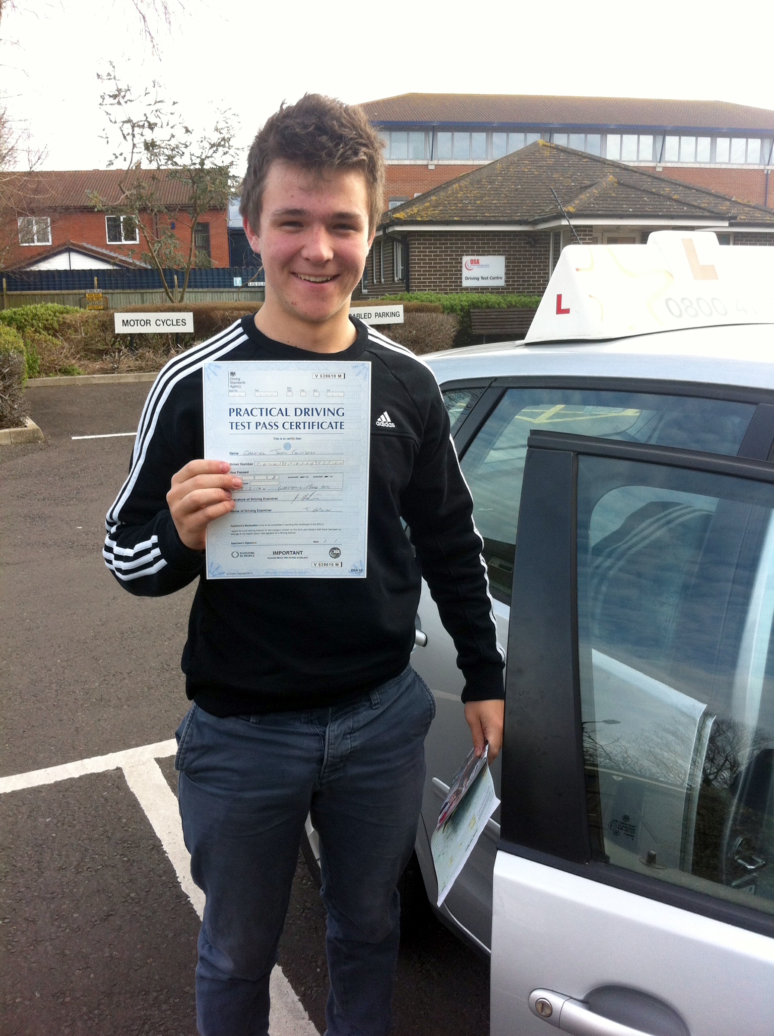 Gabriel with his Driving Test Pass Certificate outside Weston-Super -Mare Driving Test Centre