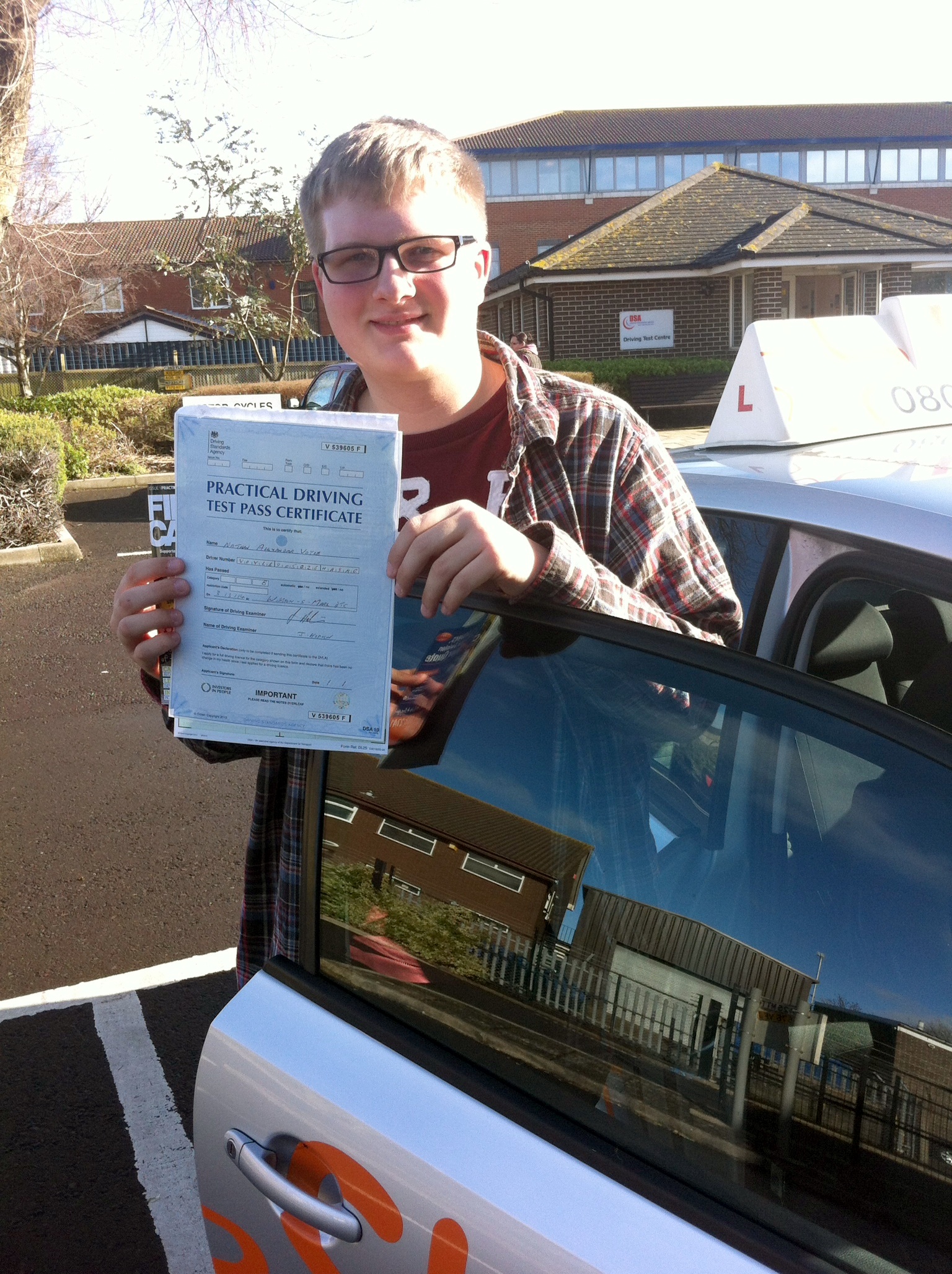 Nathan with his Practical Driving Test Pass Certificate outside Weston-super-Mare Driving Test Centre