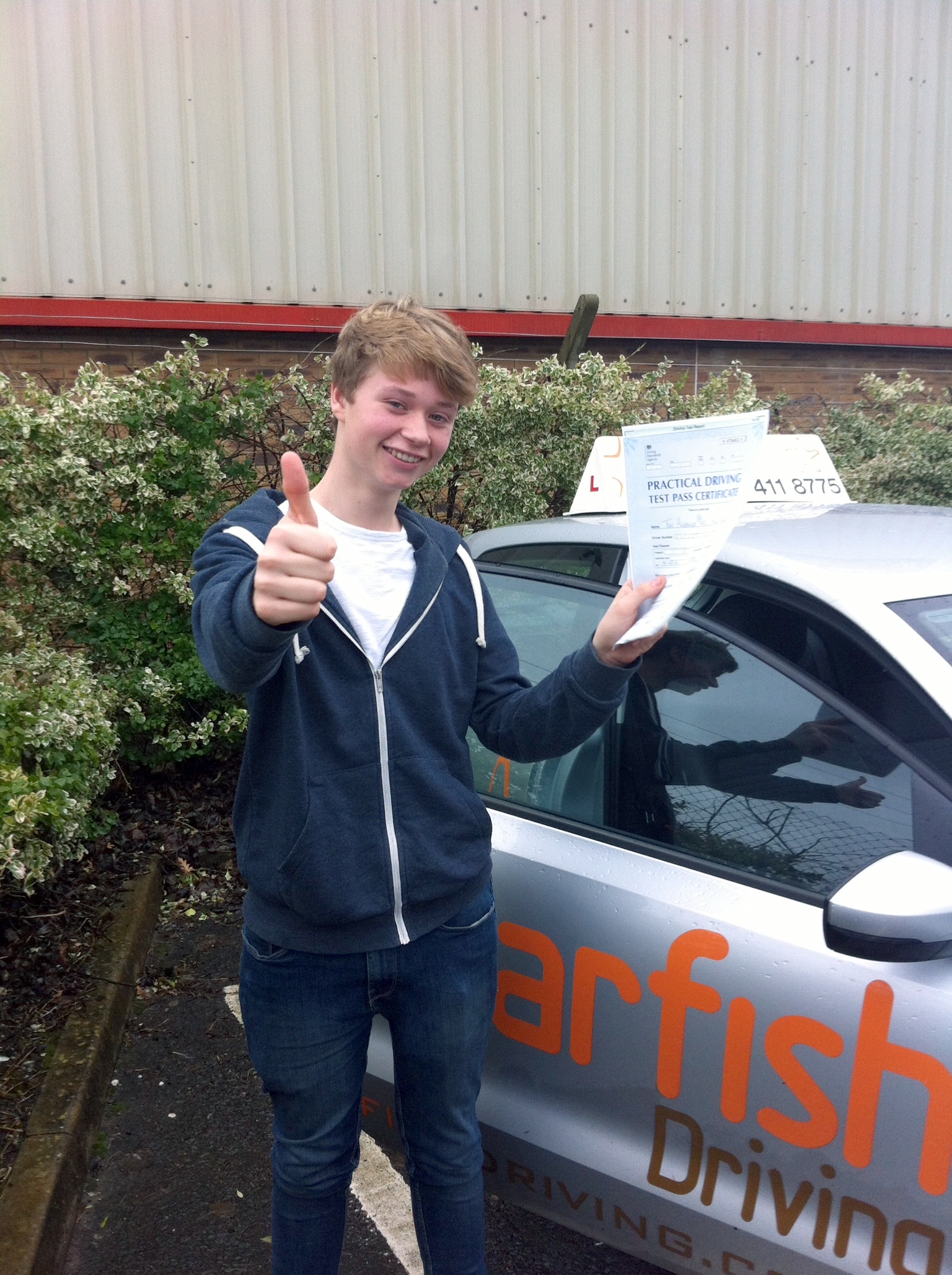 Tom with his Practical Driving Test Pass Certificate outside Weston-super-Mare Driving Test Centre