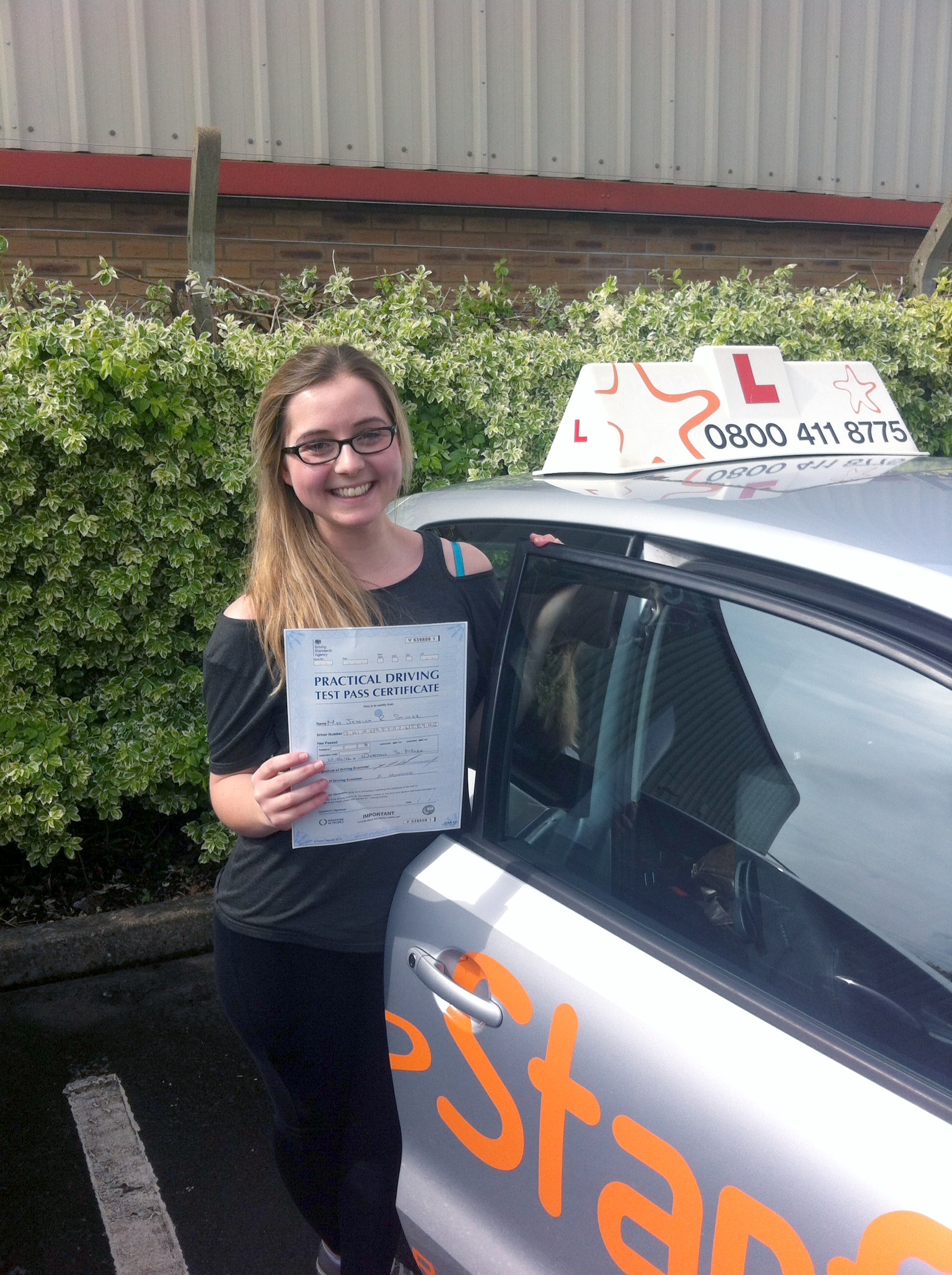 Jessica with her Practical Driving Test Pass Certificate outside Weston-super-Mare Driving Test Centre