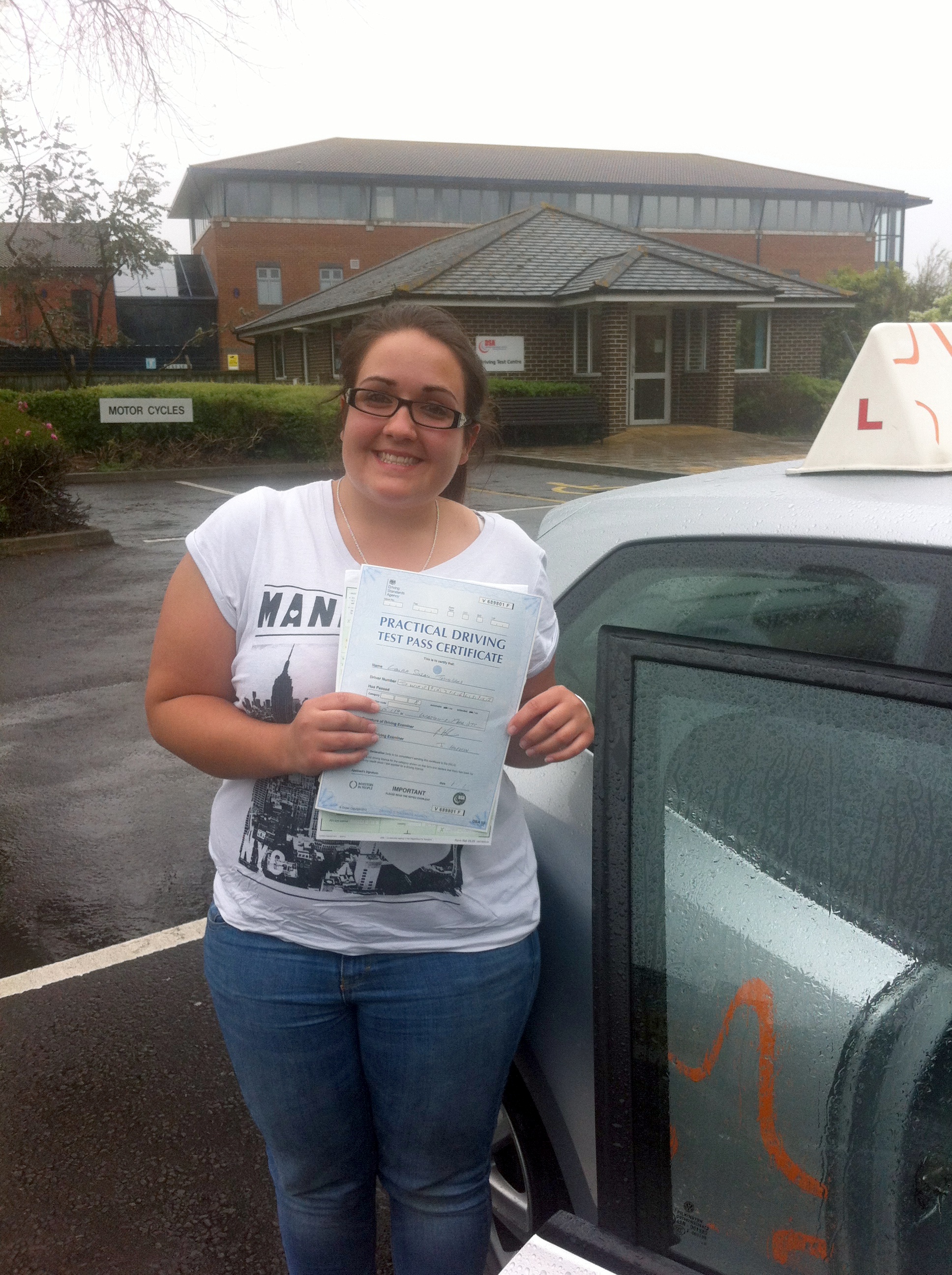 Laura with her Driving Test Pass Certificate outside Weston-super-Mare Driving Test Centre