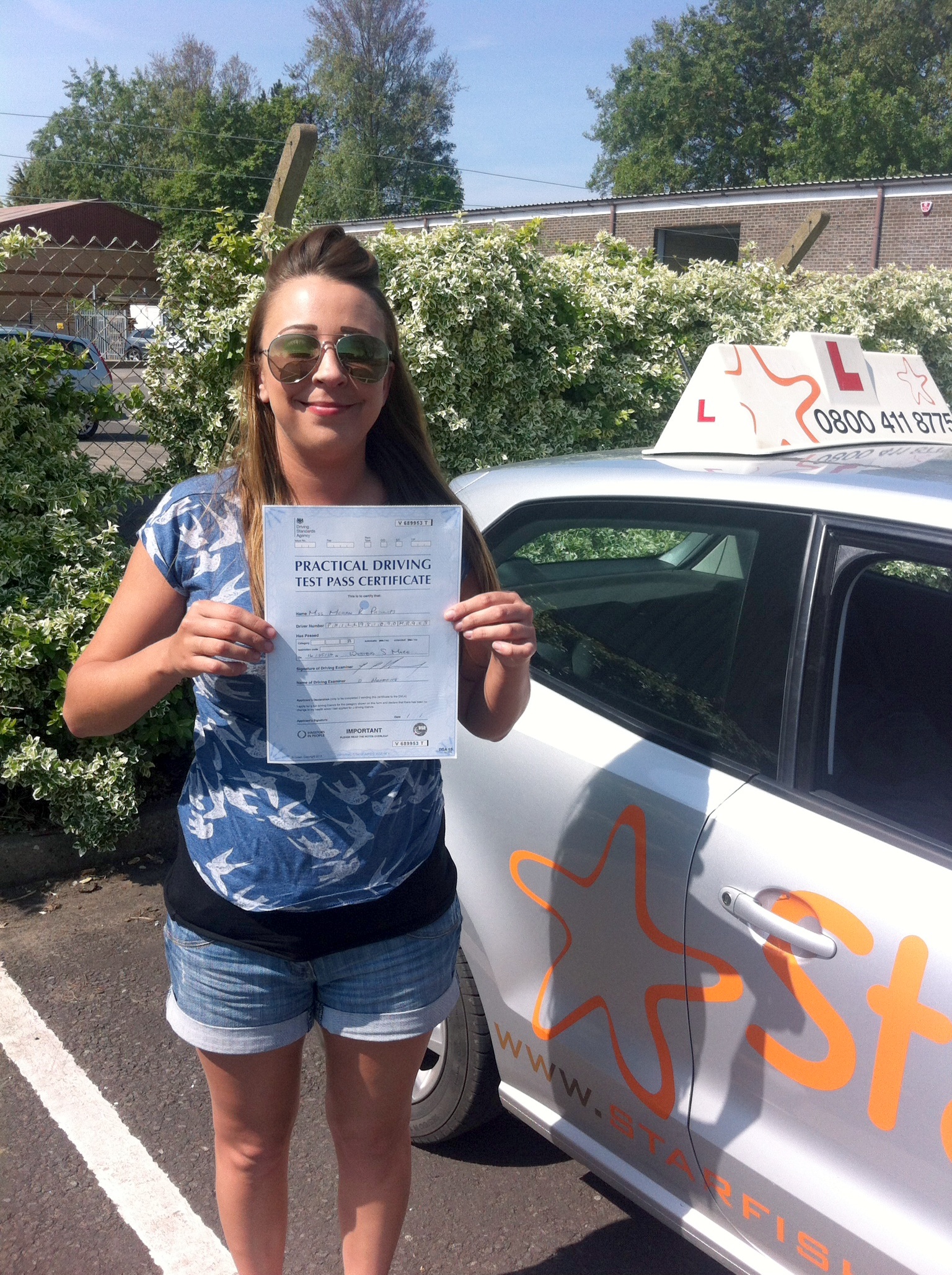 Megan with her Pracitcal Driving Test Pass Certificate outside Weston-Super-Mare Driving Test Centre