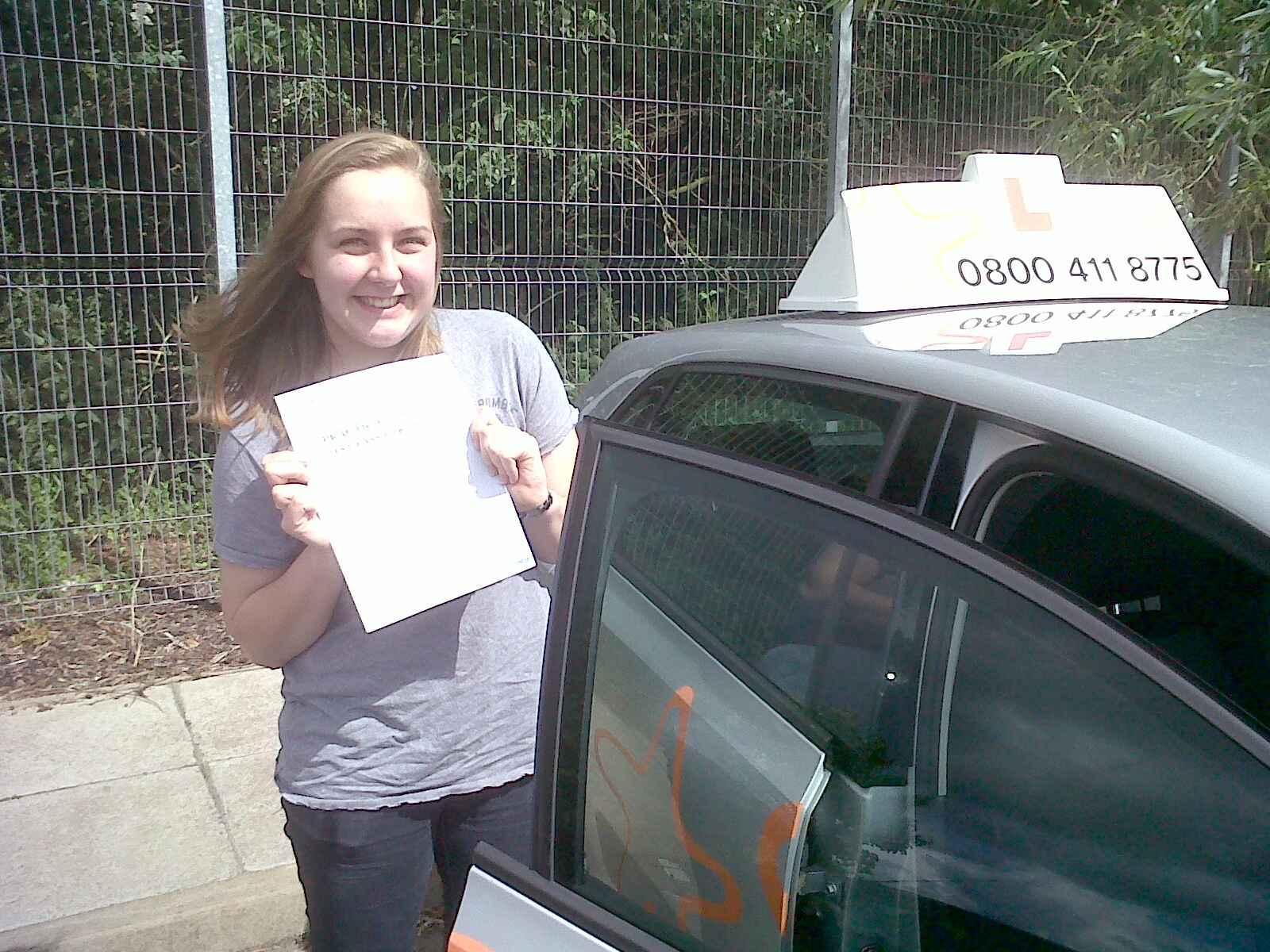 Annabel with her Practcal Driving Test Pass Certificate outside Taunton Driving Test Centre.