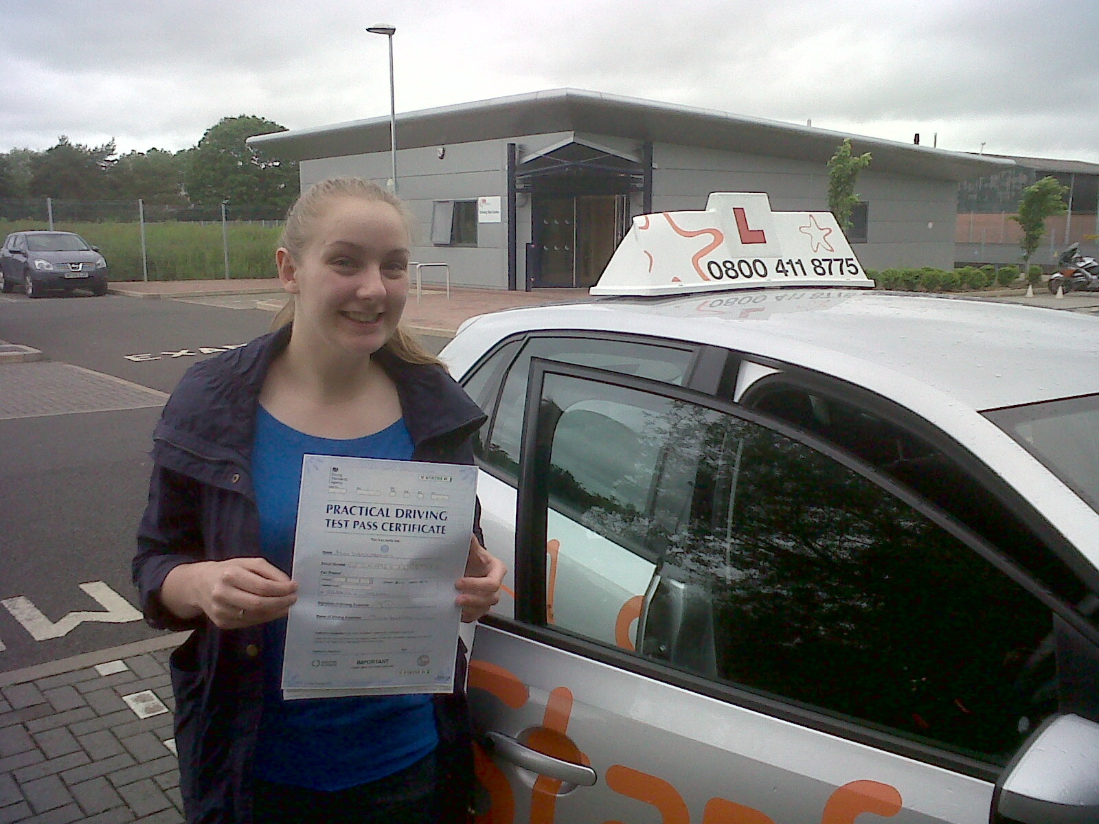 Daisy with her Practical Driving Test Pass Certificate outside Taunton Driving Test Centre.