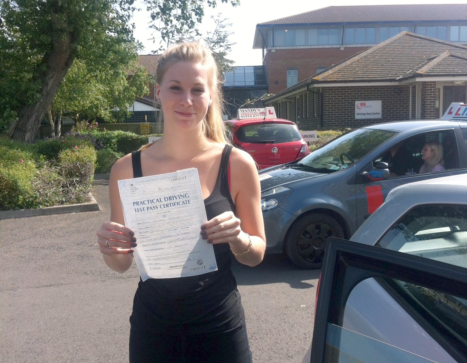 Lauren with her Practical Driving Test Pass Certificate outside Weston-super-Mare Driving Test Centre.