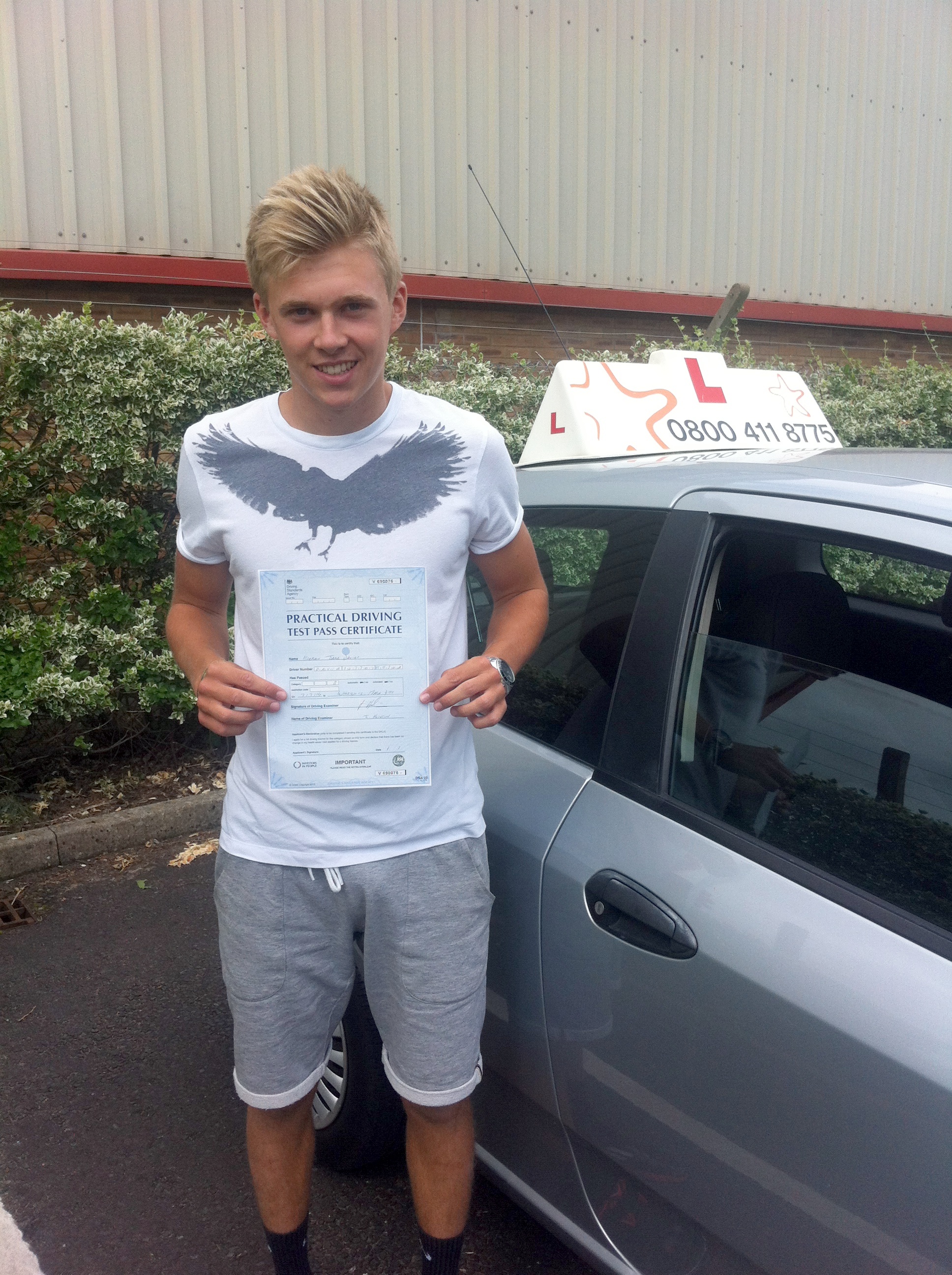 Kieran with his Practical Driving Test Pass Certificate outside Weston-super-Mare Driving Test Centre