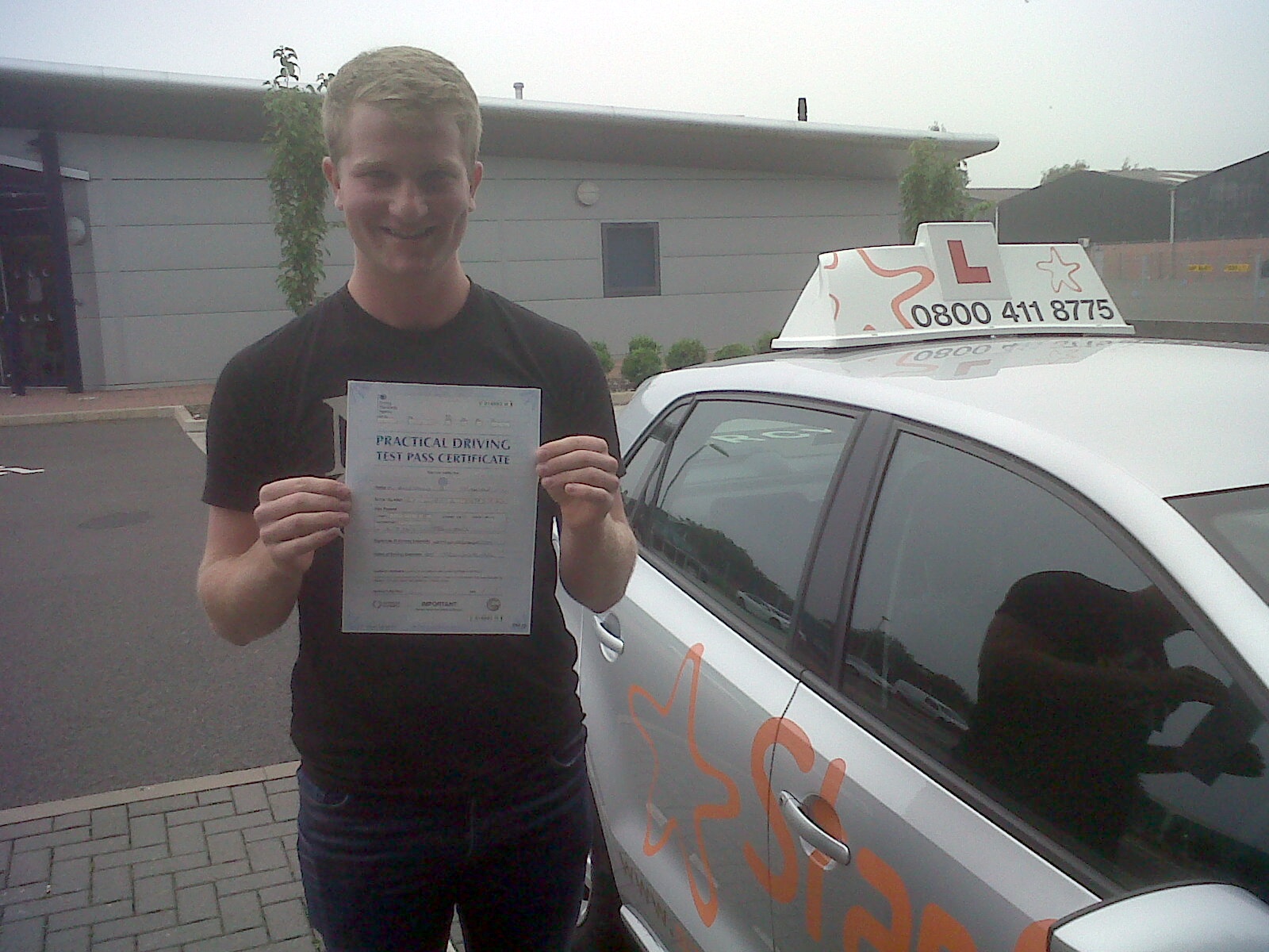Ben with his Practical Driving Test Pass Certificate outside Taunton Driving Test Centre.