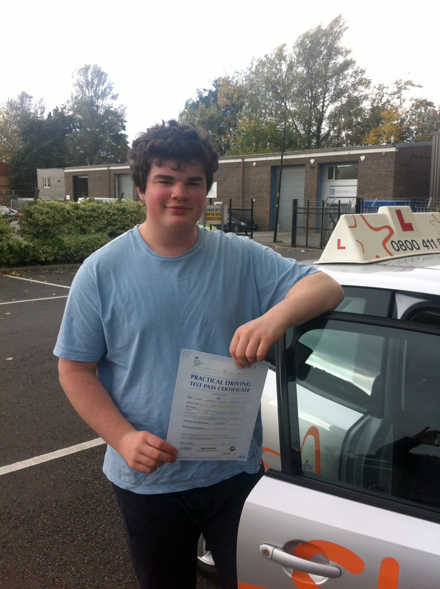 Owen with his Practical Driving Test Pass Certificate outside Weston-super-Mare Driving Test Centre