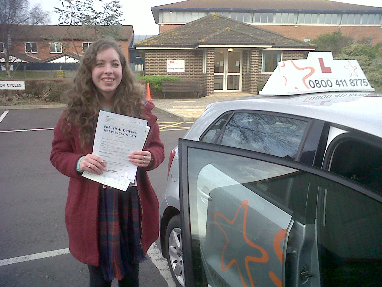 Abby with her Practical Driving Test Pass Certificate outside Weston-super-mare Driving Test Centre.