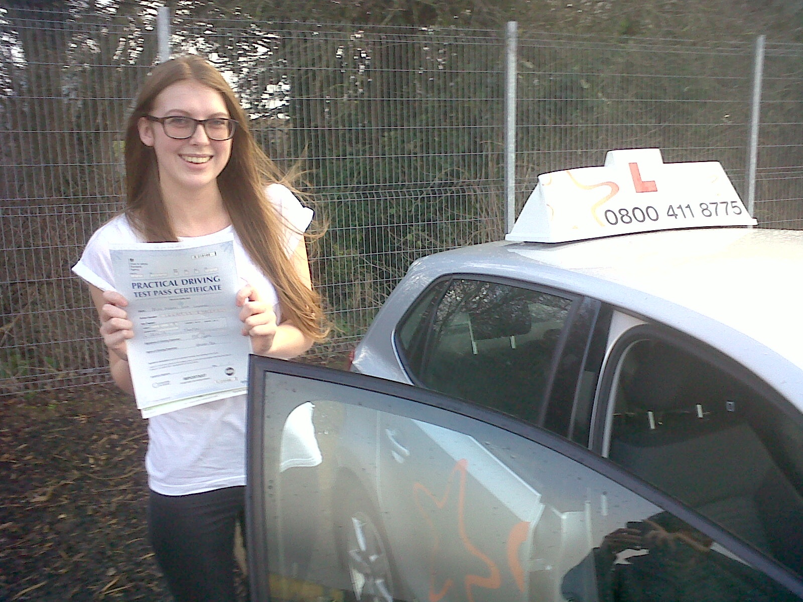 Megan with her Practical Driving Test Pass Certificate outside Taunton Driving Test Centre