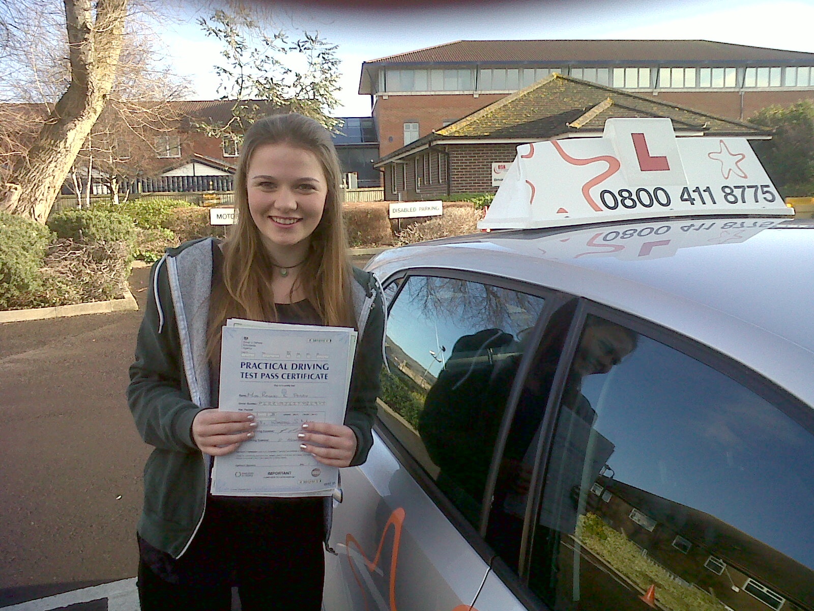 Rachel with her Practical Driving Test Pass Certificate outside Weston-super-mare Driving Test Centre
