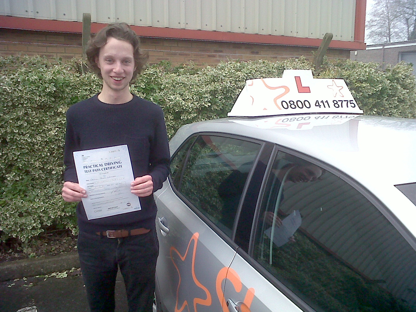 Gabe with his Practical Driving Test Pass Certificate outside Weston-super-Mare Driving Test Centre.
