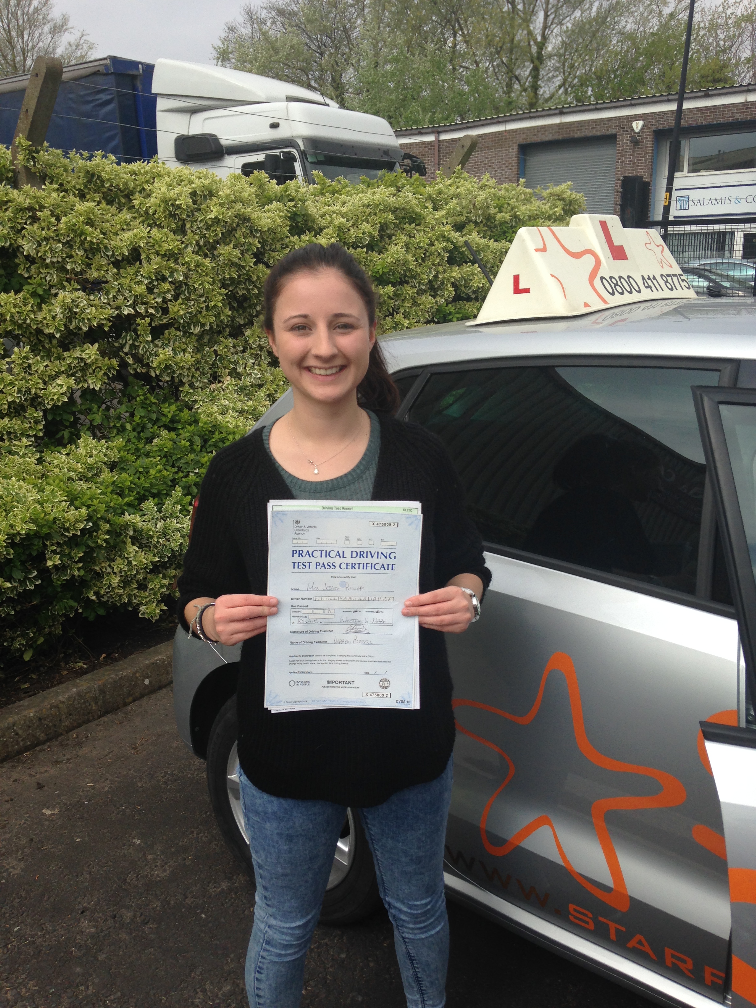 Jess with her Practical Driving Test Pass Certificate outside Weston-super-mare Driving Test Centre.