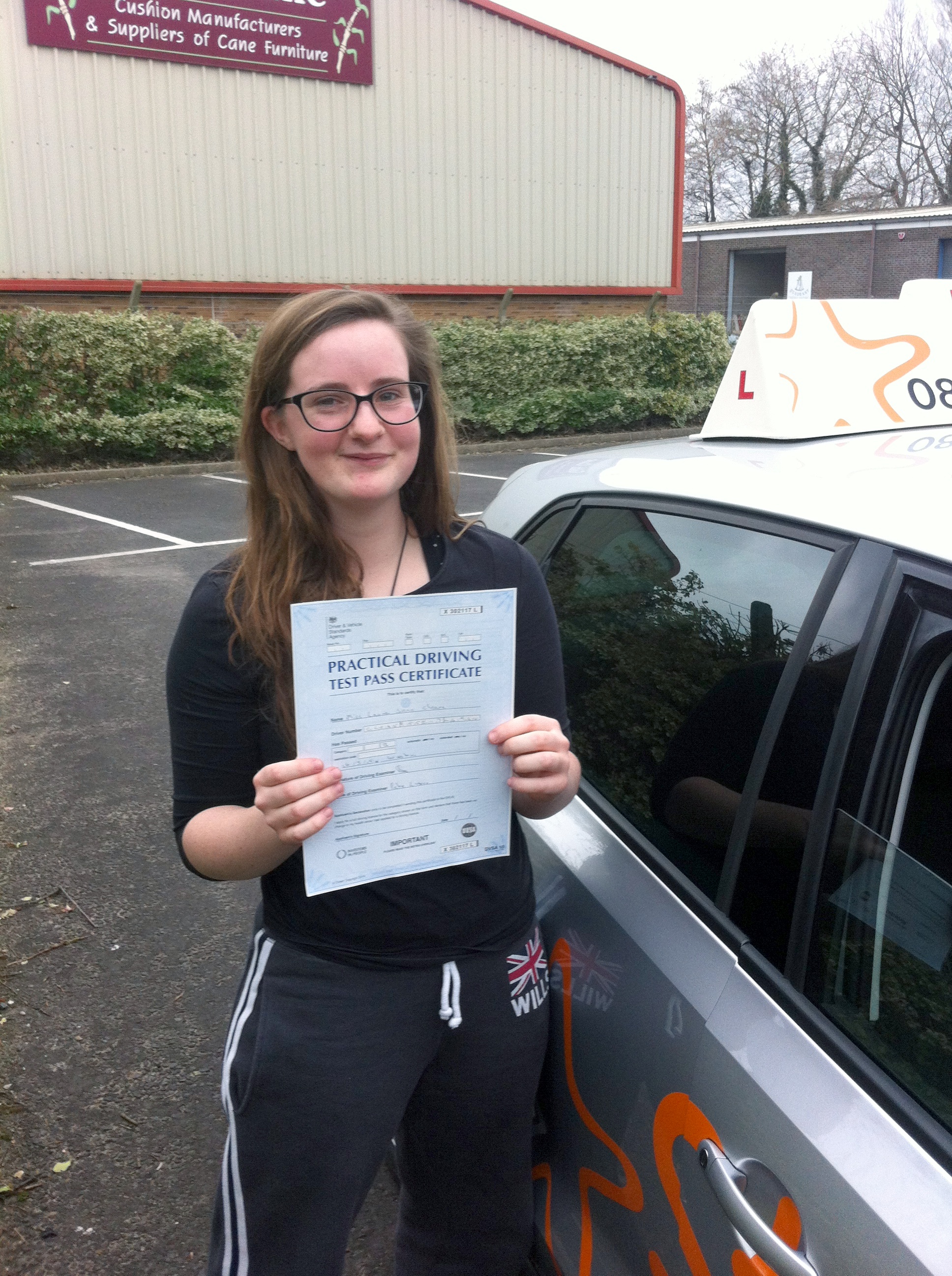 Lauren with her Practical Driving Test Pass Certificate outside Weston-super-Mare Driving Test Centre.