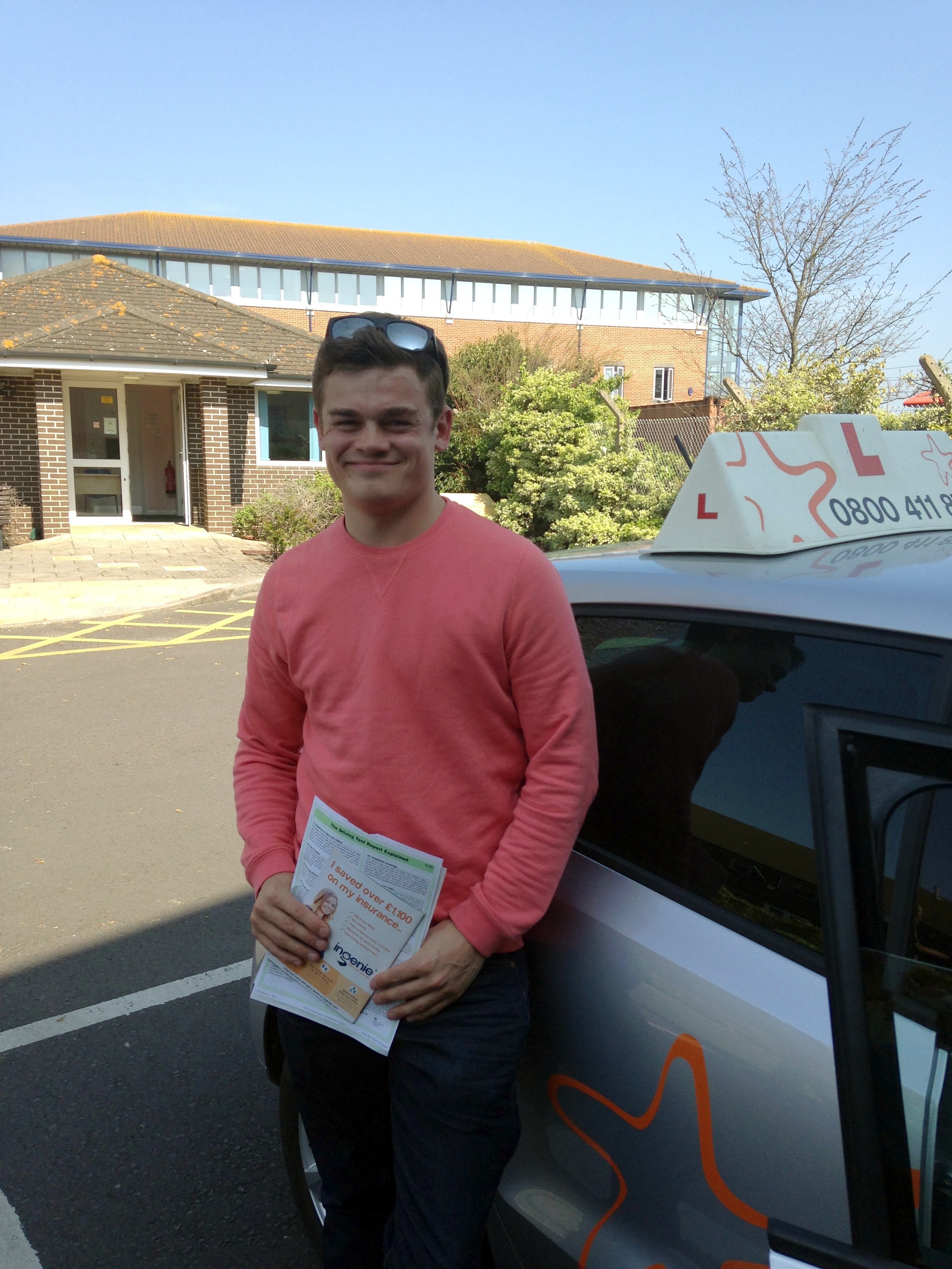 Sam with his Practical Driving Test Certificate outside Weston-Super-Mare Driving Test Centre.
