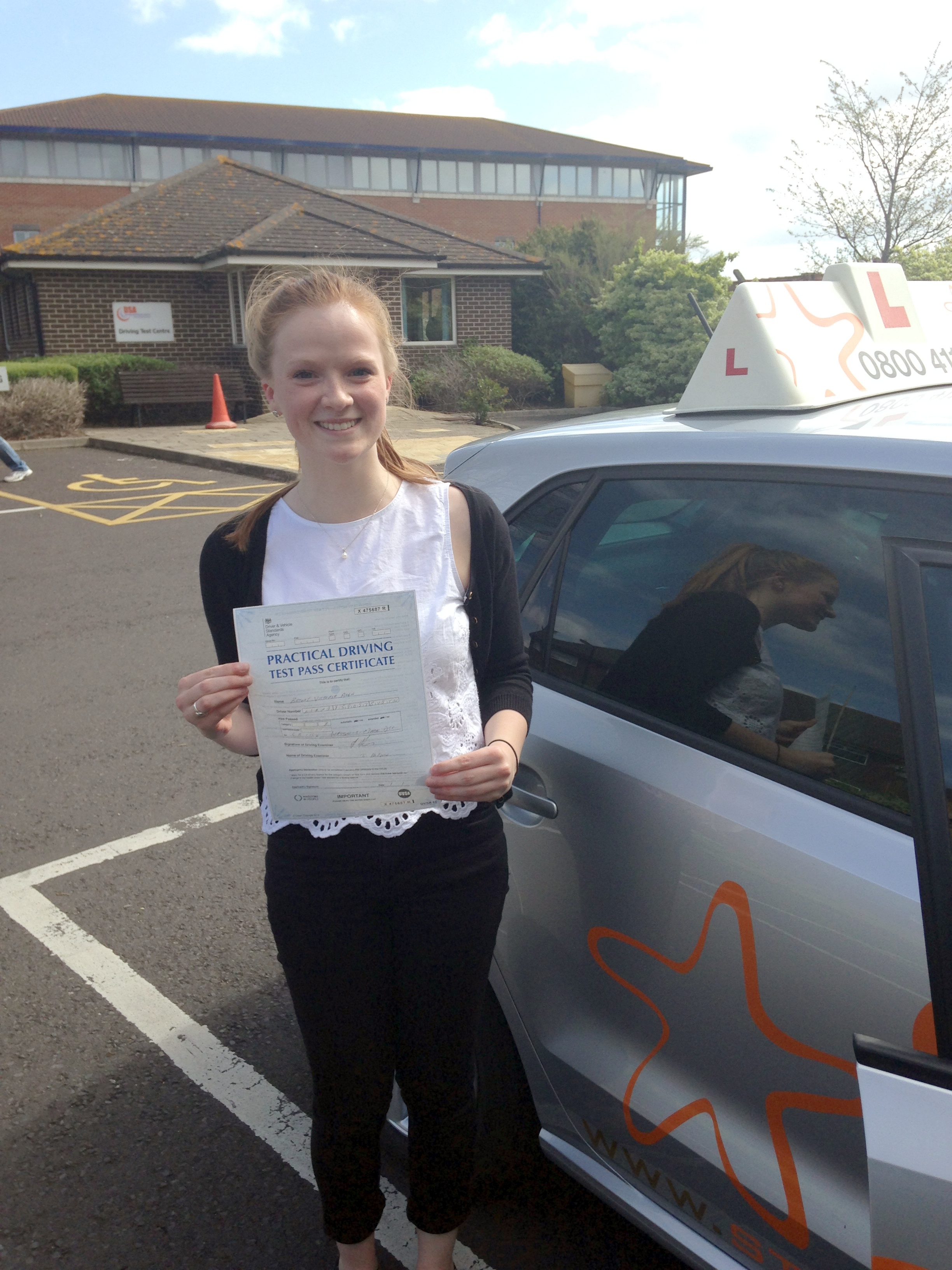 Bryony with her Practical Driving Test Pass Certificate outside Weston-super-Mare Driving Test Centre.