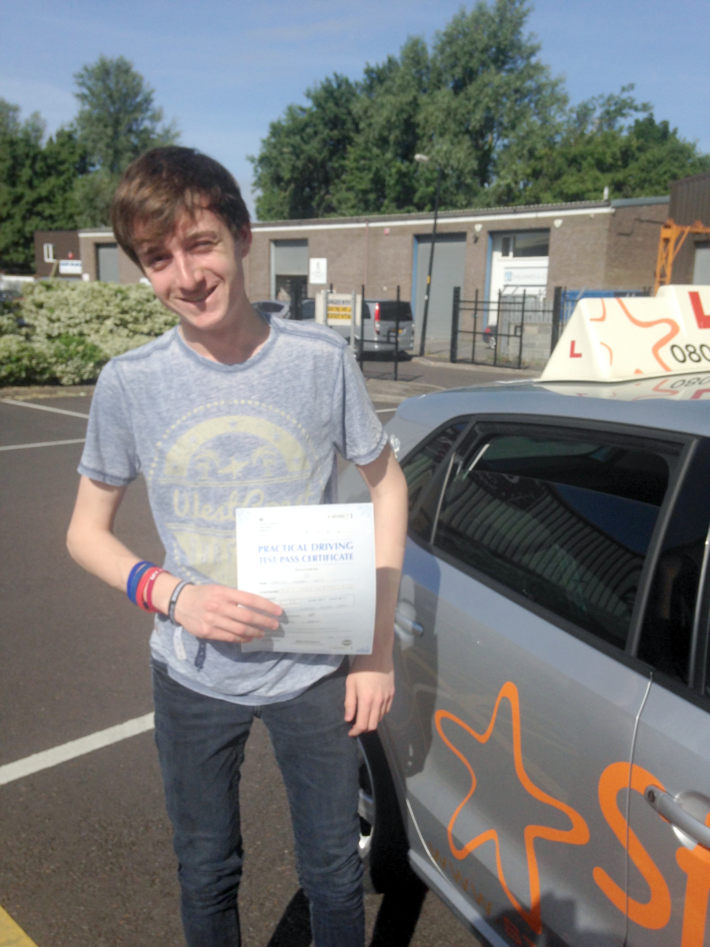 Charlie with his Practical Driving Test Pass Certificate outside Weston-super-mare Driving Test Centre