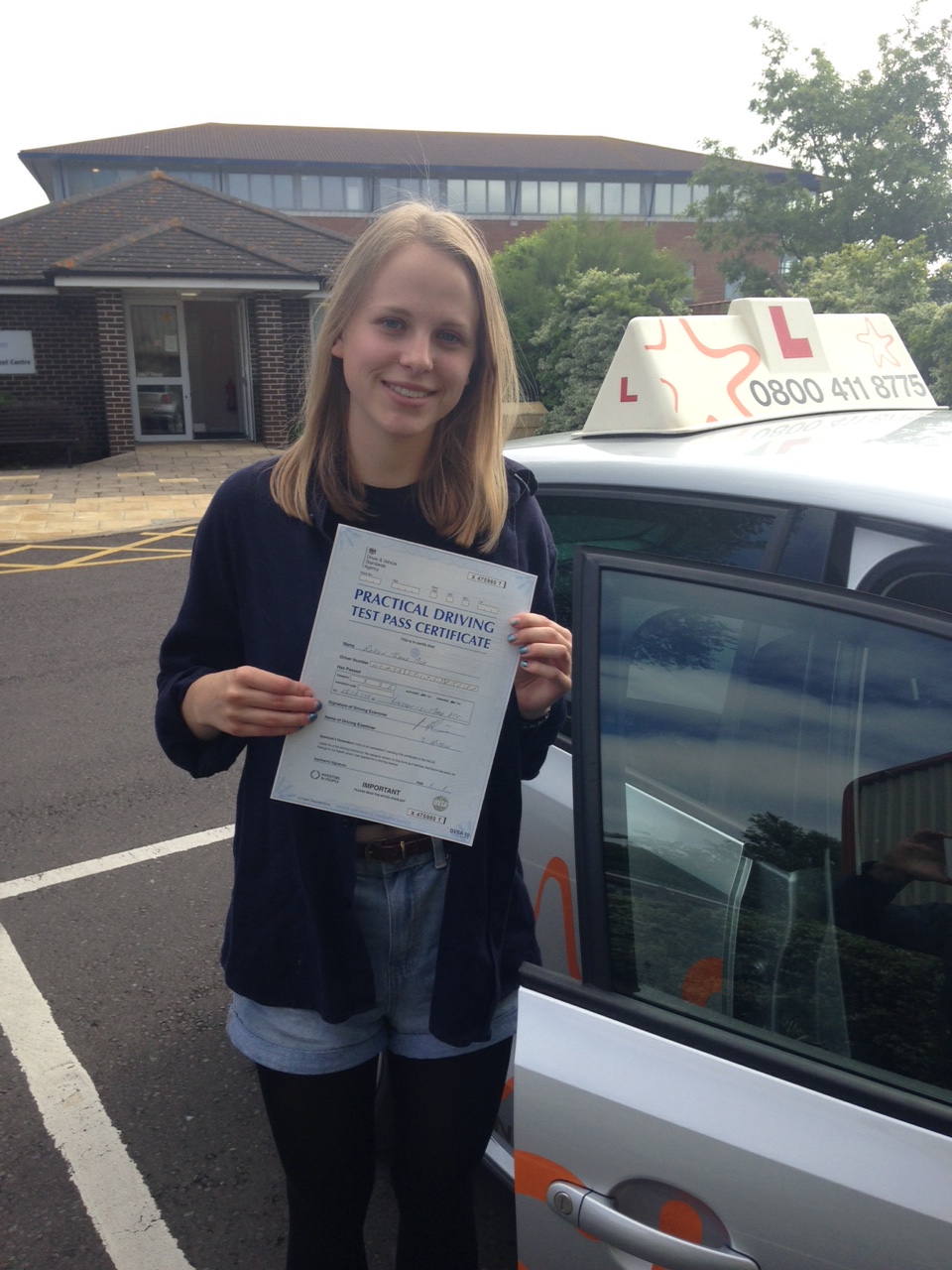 Robyn with her Practical Driving Test Pass Certificate outside Weston-Super-Mare Driving Test Centre.