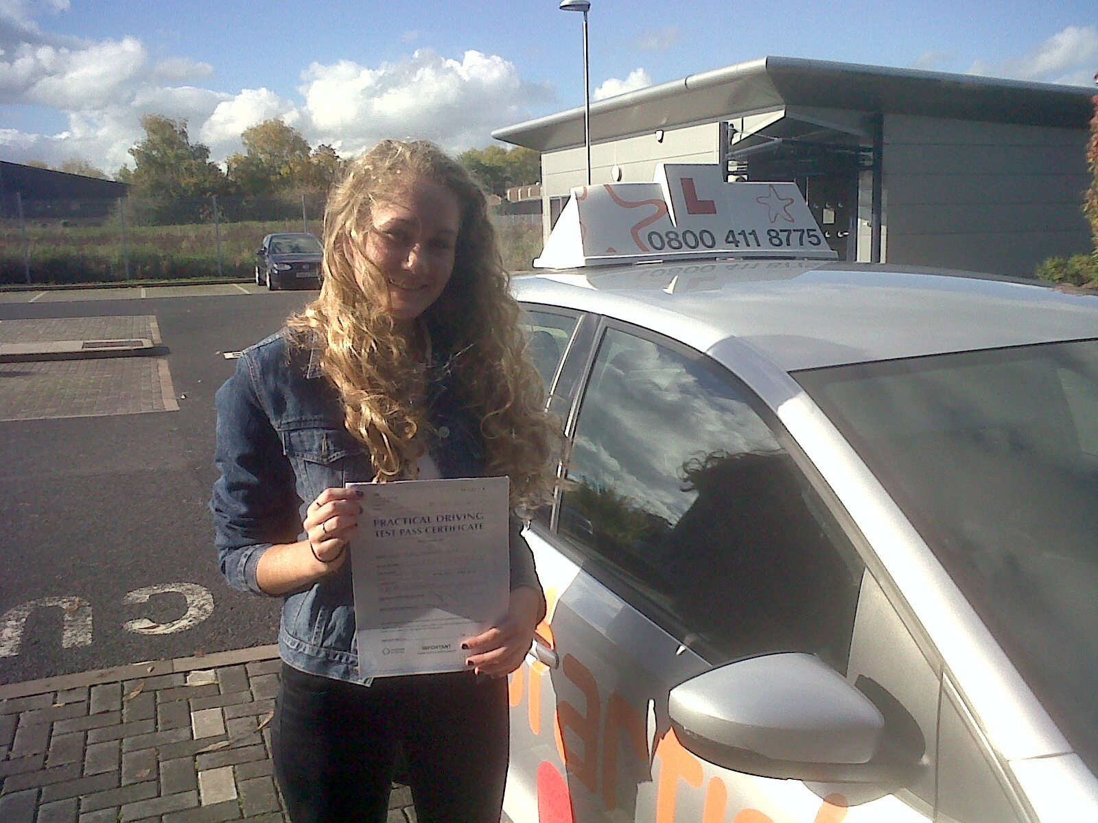 Poppy with her Practical Driving Test Pass Certificate outside Weston-super-Mare Driving Test Centre