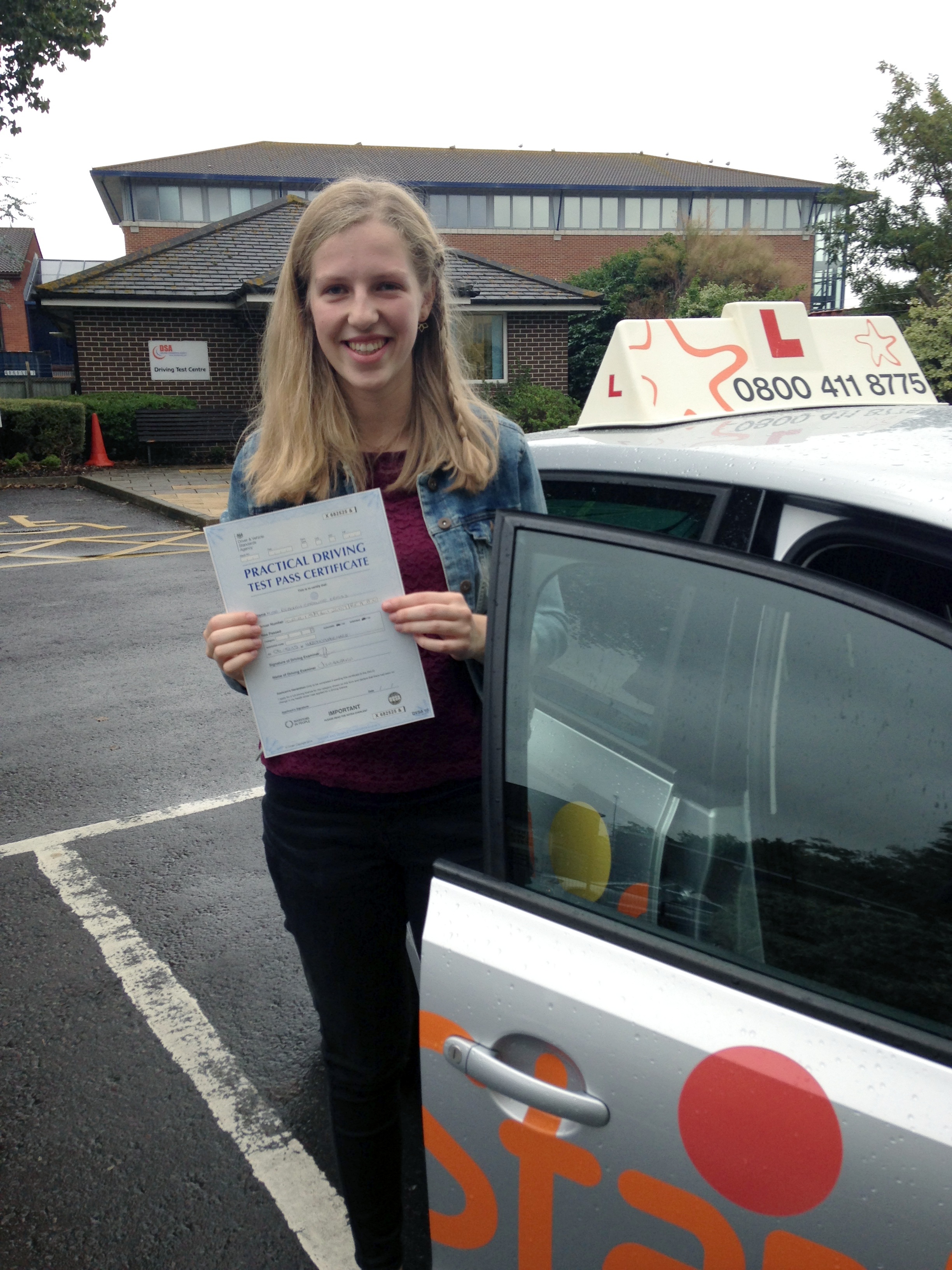 Rebecca with her Practical Driving Test Pass Certificate outside Weston-super-Mare Driving Test Centre.