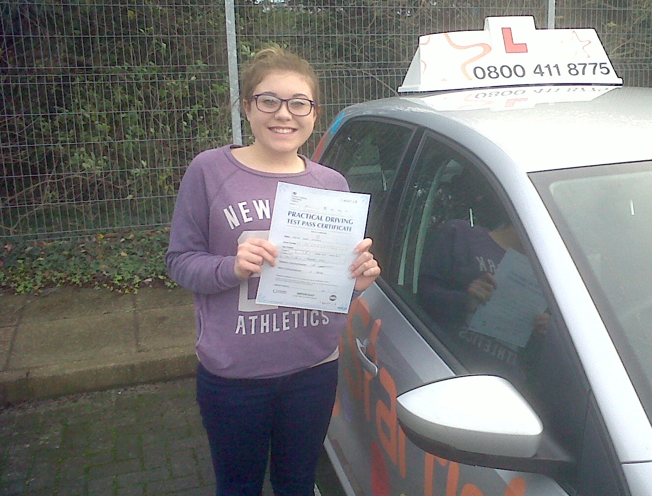 Katie with her Practical Driving Test Pass Certificate outside Taunton Driving Test Centre