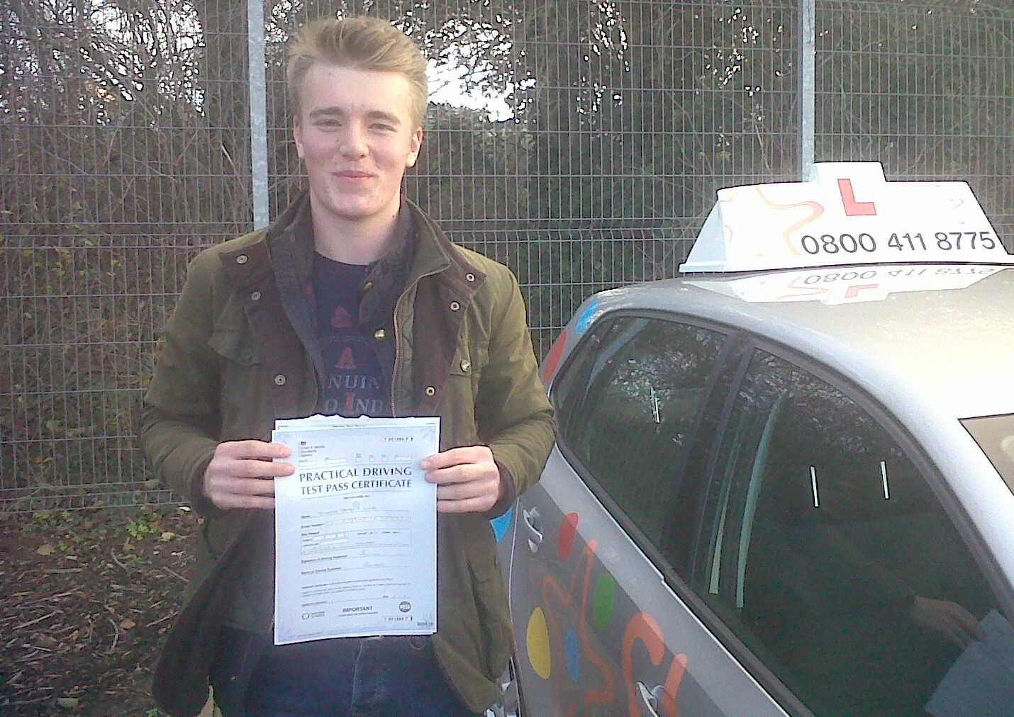 Tim with his Practical Driving Test Pass Certificate outside Taunton Driving Test Centre.