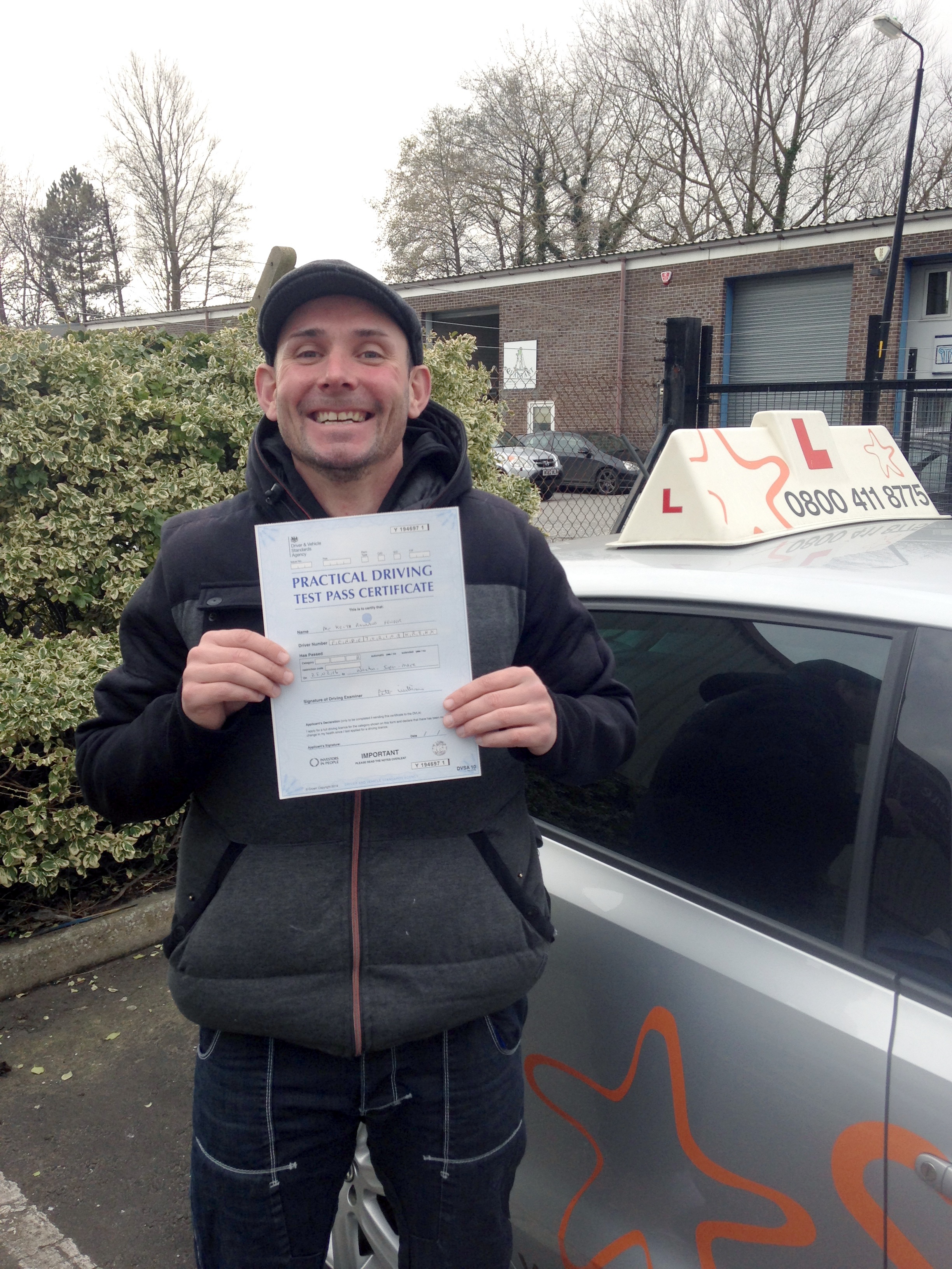 Keith with his Practical Driving Test Pass Certificate outside Weston-super-Mare Driving Test Centre