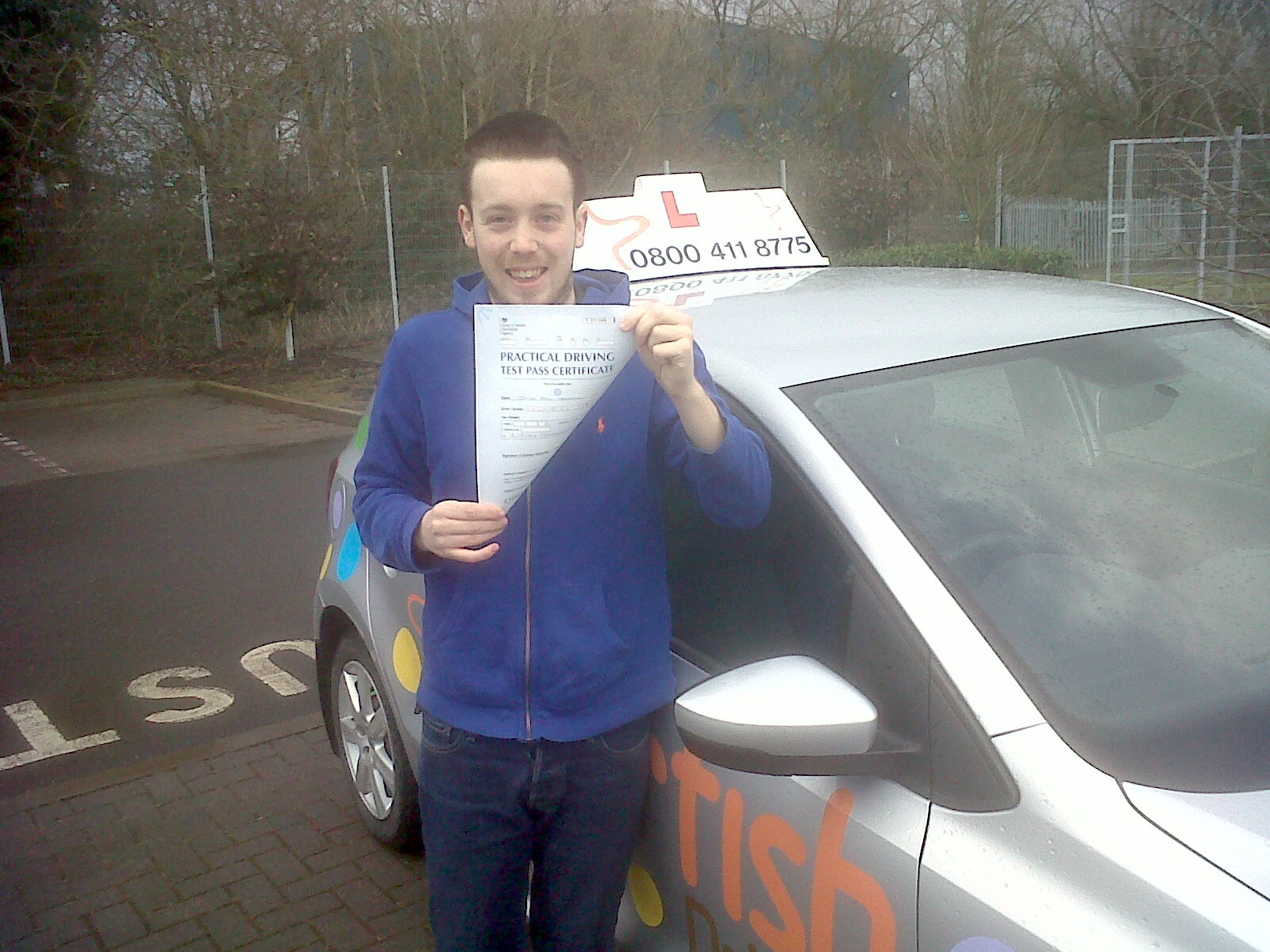 Jacob holding on tightly to his Practical Driving Test Certificate outside Taunton Driving Test Centre