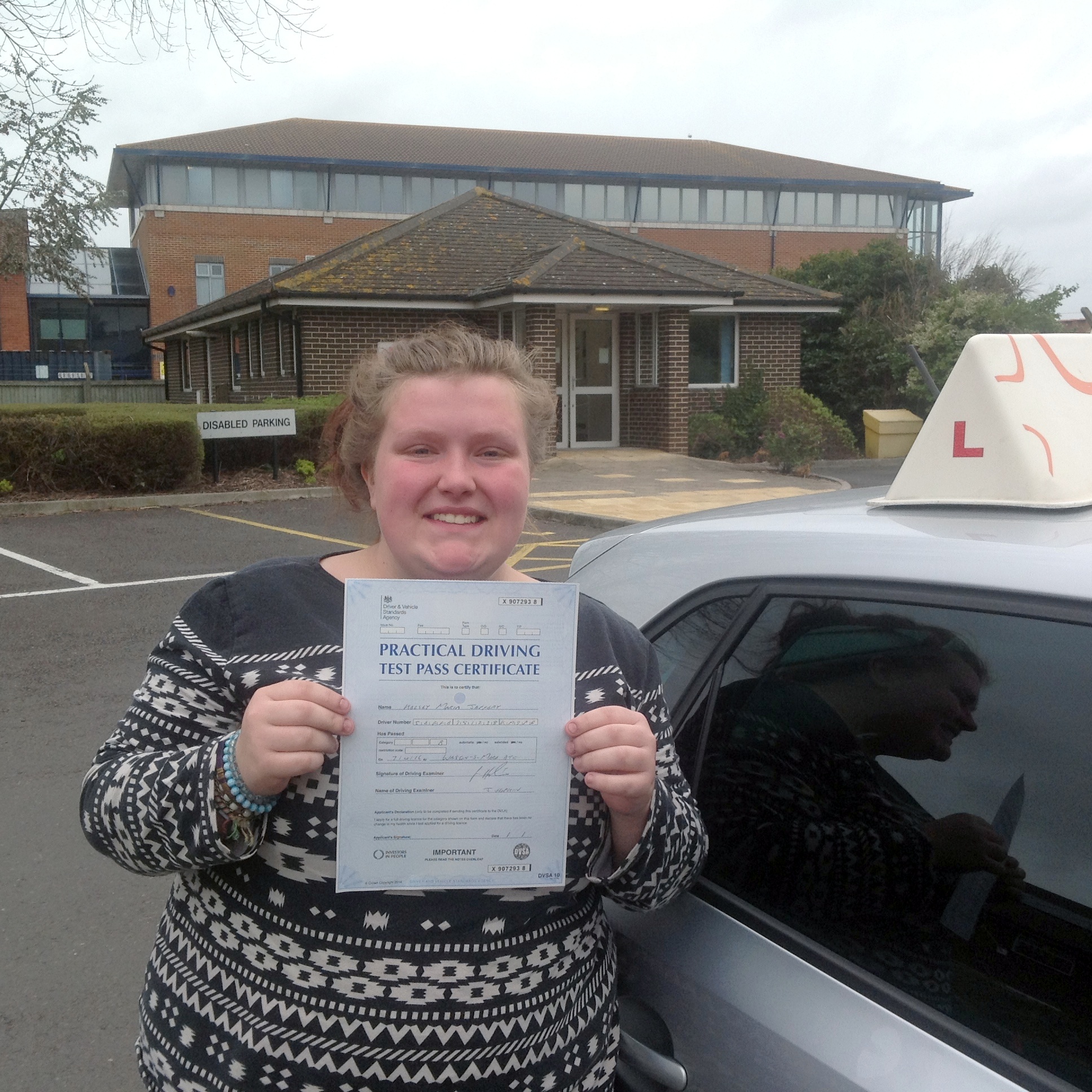 Kelsey with her Practical Driving Test Pass Certificate outside Weston-Super-Mare Driving Test Centre.