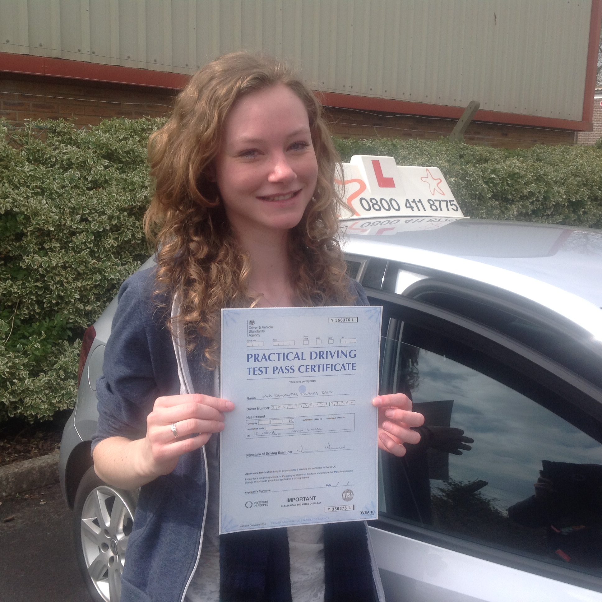 Sam with her Practical Driving Test Pass Certificate outside Weston-Super-Mare Driving Test Centre