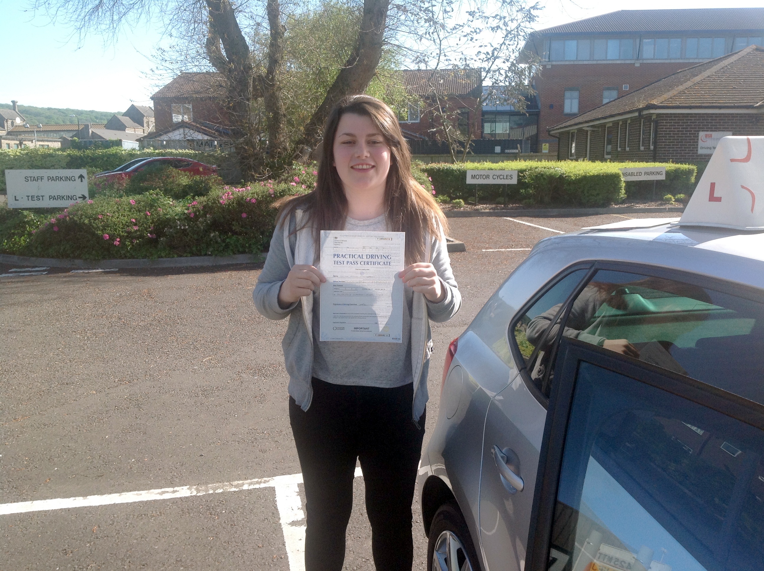Alice with her Practical Driving Test Pass Certificate outside Weston-super-Mare Driving Test Centre