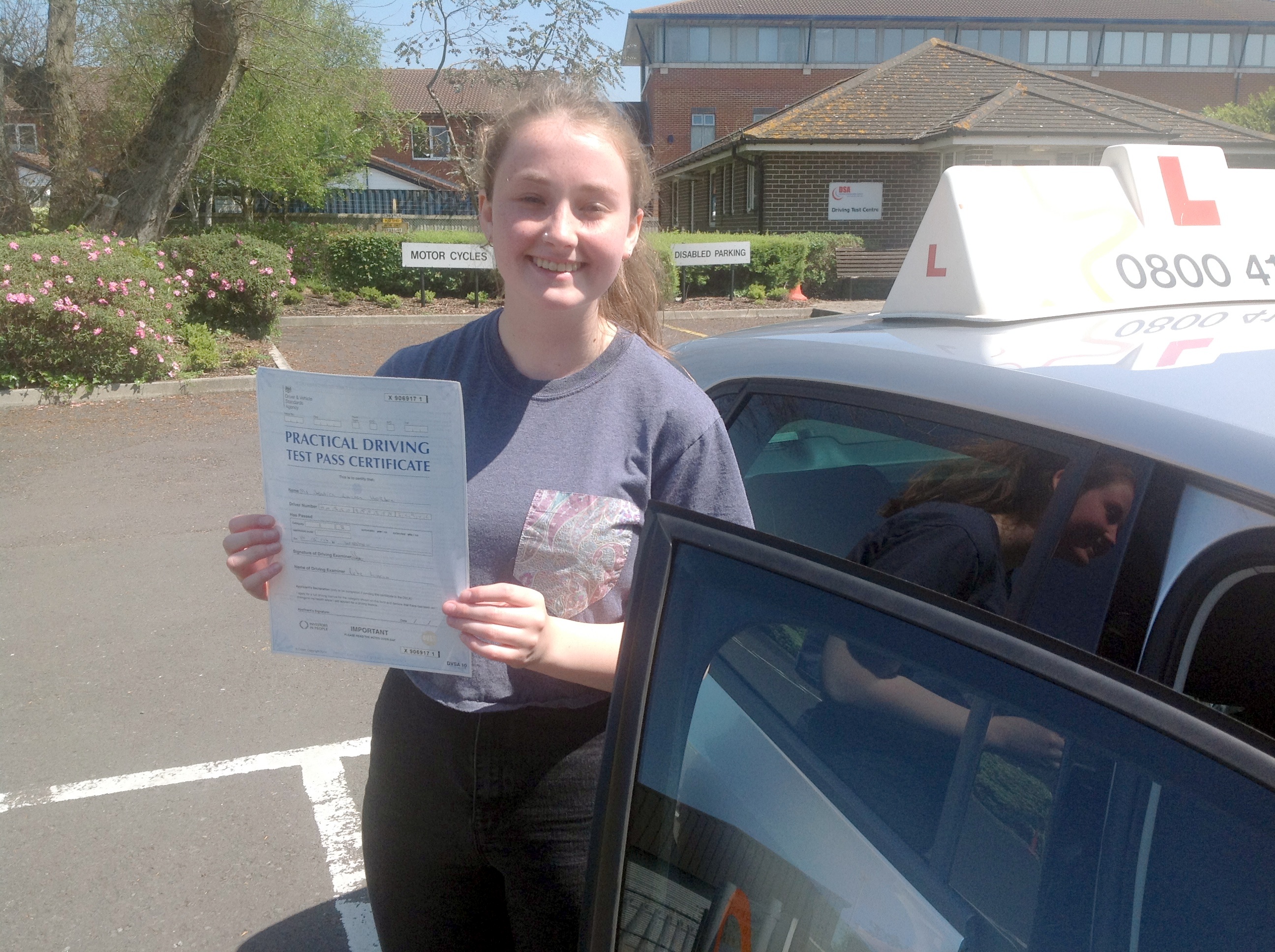 Jessica with her Practical Driving Test Pass Certificate outside Weston-super-Mare Driving Test Station.