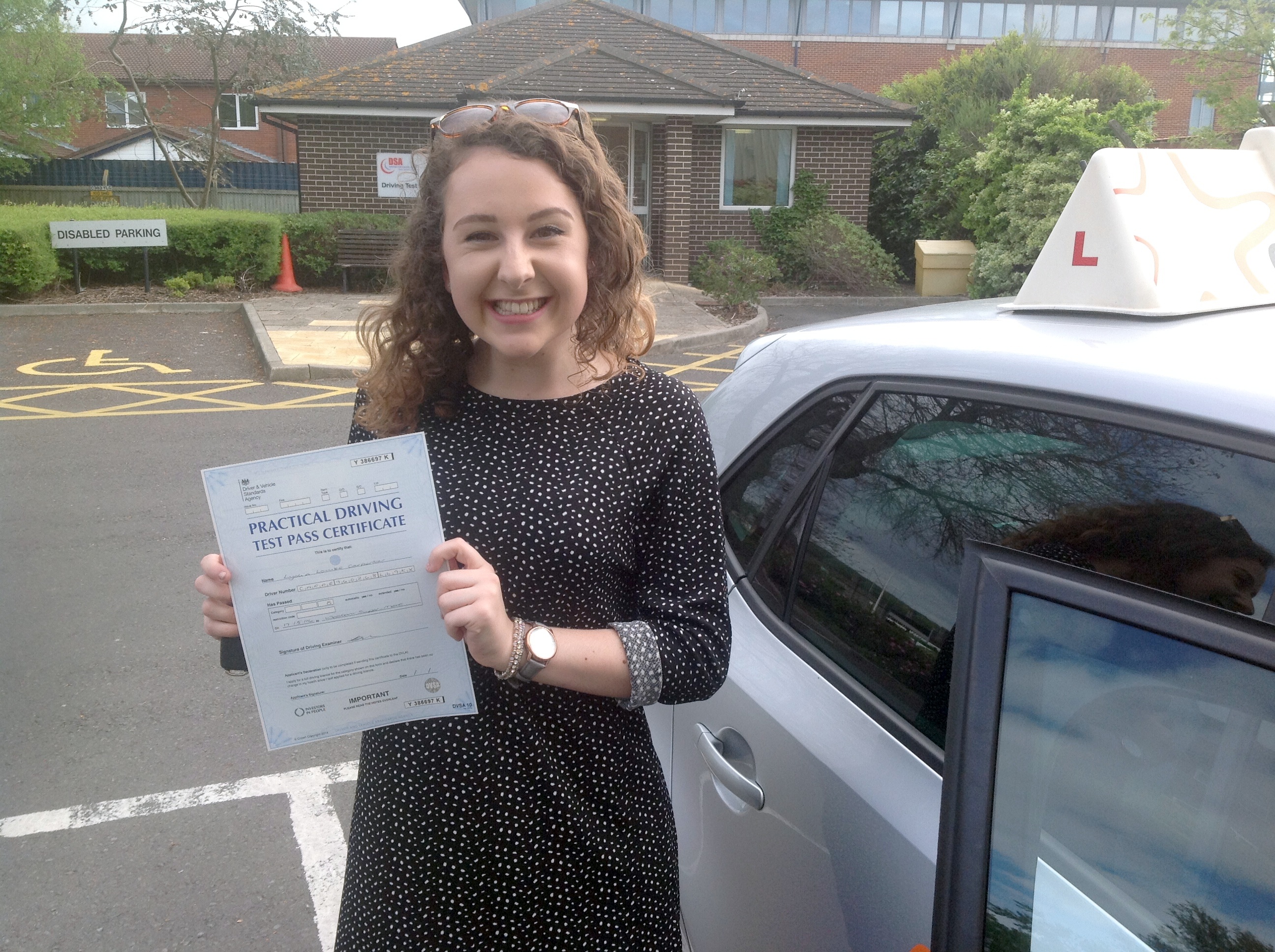 Lydia with her Practical Driving Test Pass Certificate outside Weston-Super-Mare Driving Test Centre