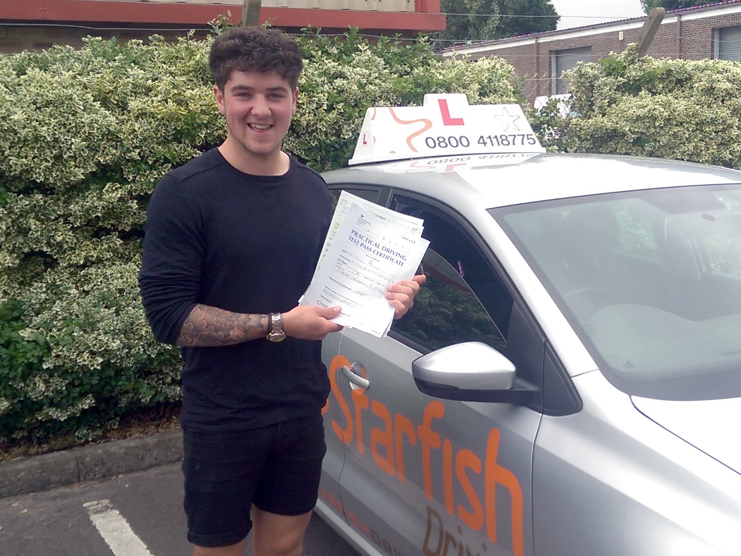 Felix with his Practical Driving Test Pass Certificate outside Weston-super-Mare Driving Test Centre