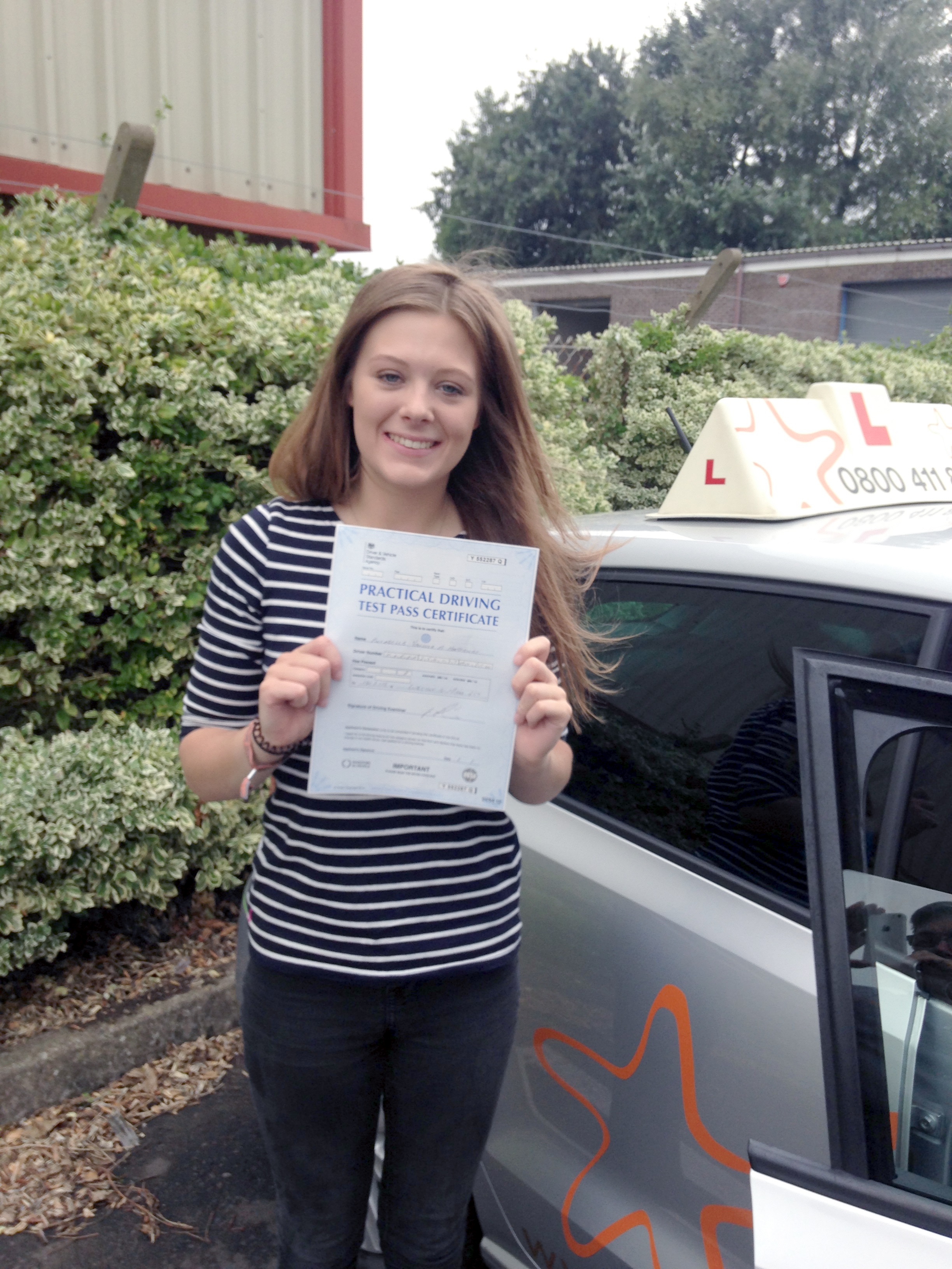 Annabel with her Practical Driving Test Pass Certificate outside Weston-Super-Mare Driving Test Centre